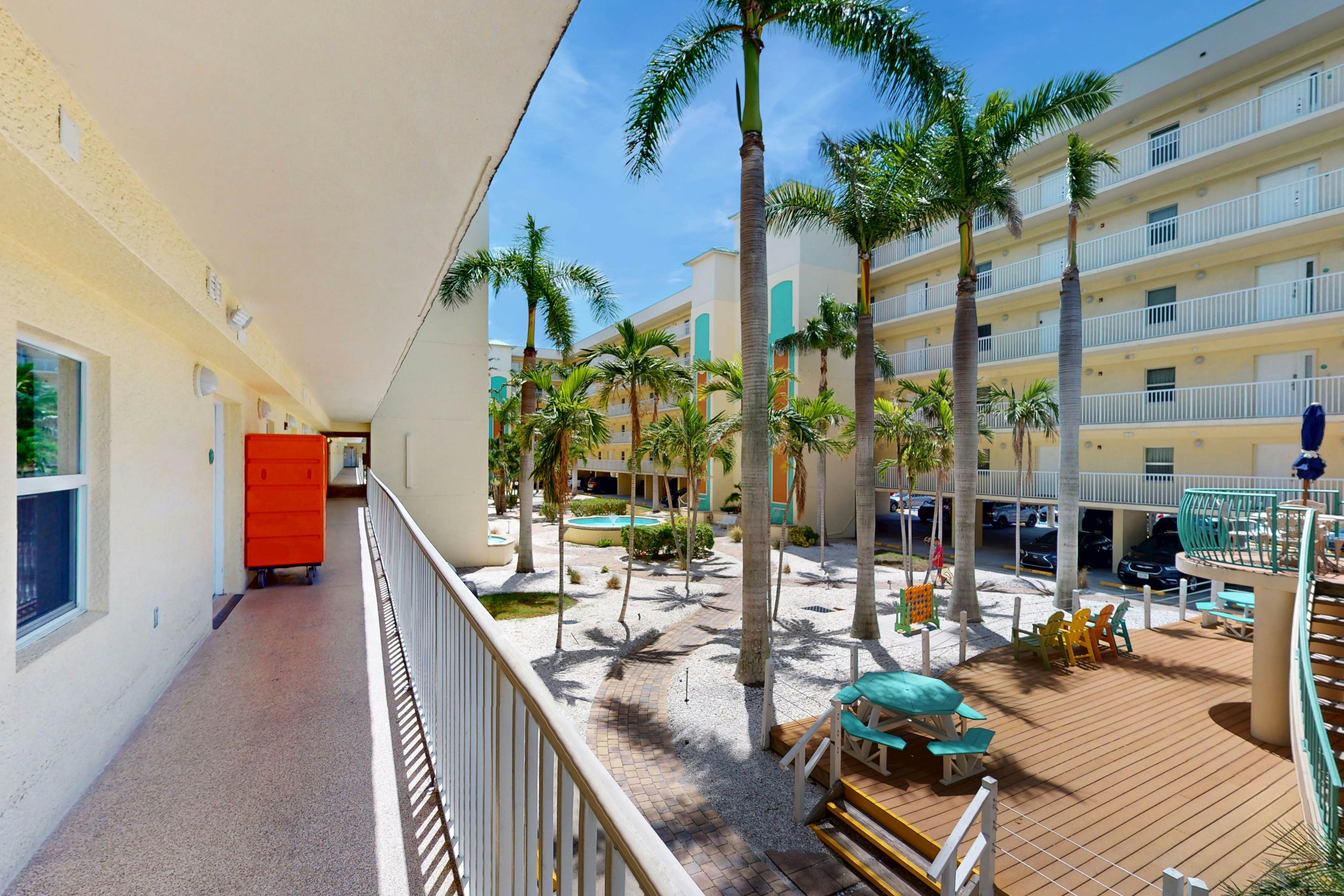 Second-floor condo with beach access, balcony, pool, hot tubs, and ping-pong