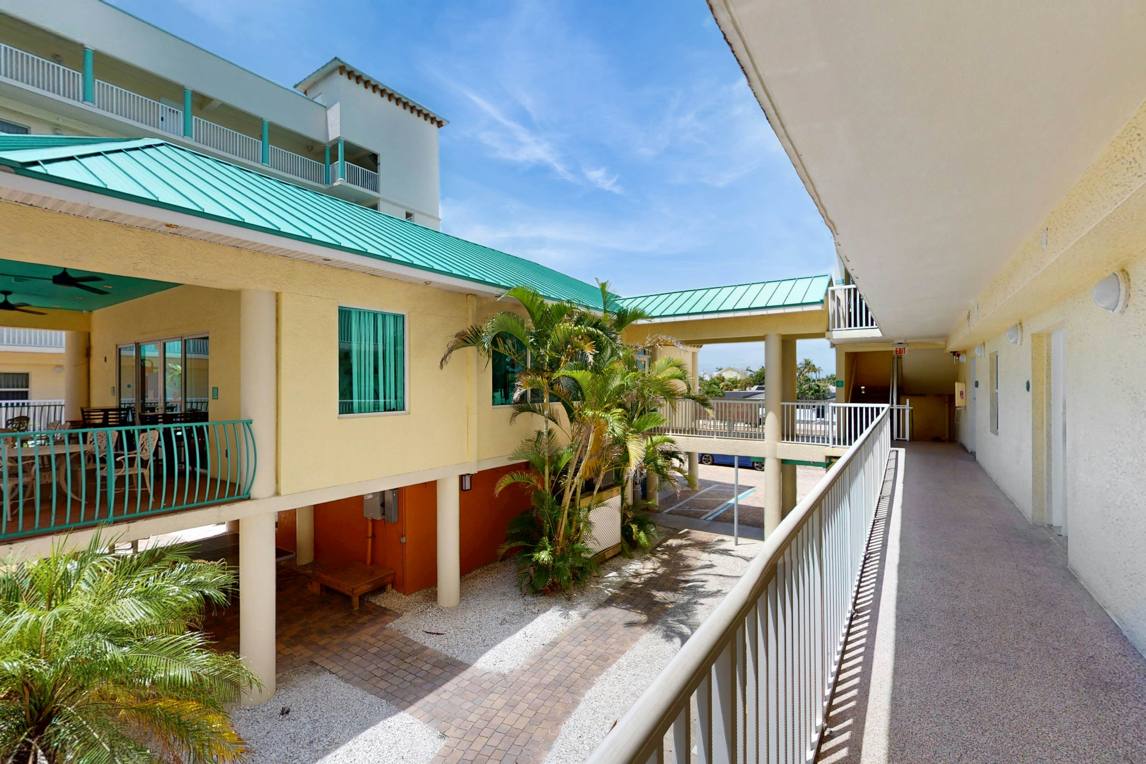 Second-floor condo with beach access, balcony, pool, hot tubs, and ping-pong