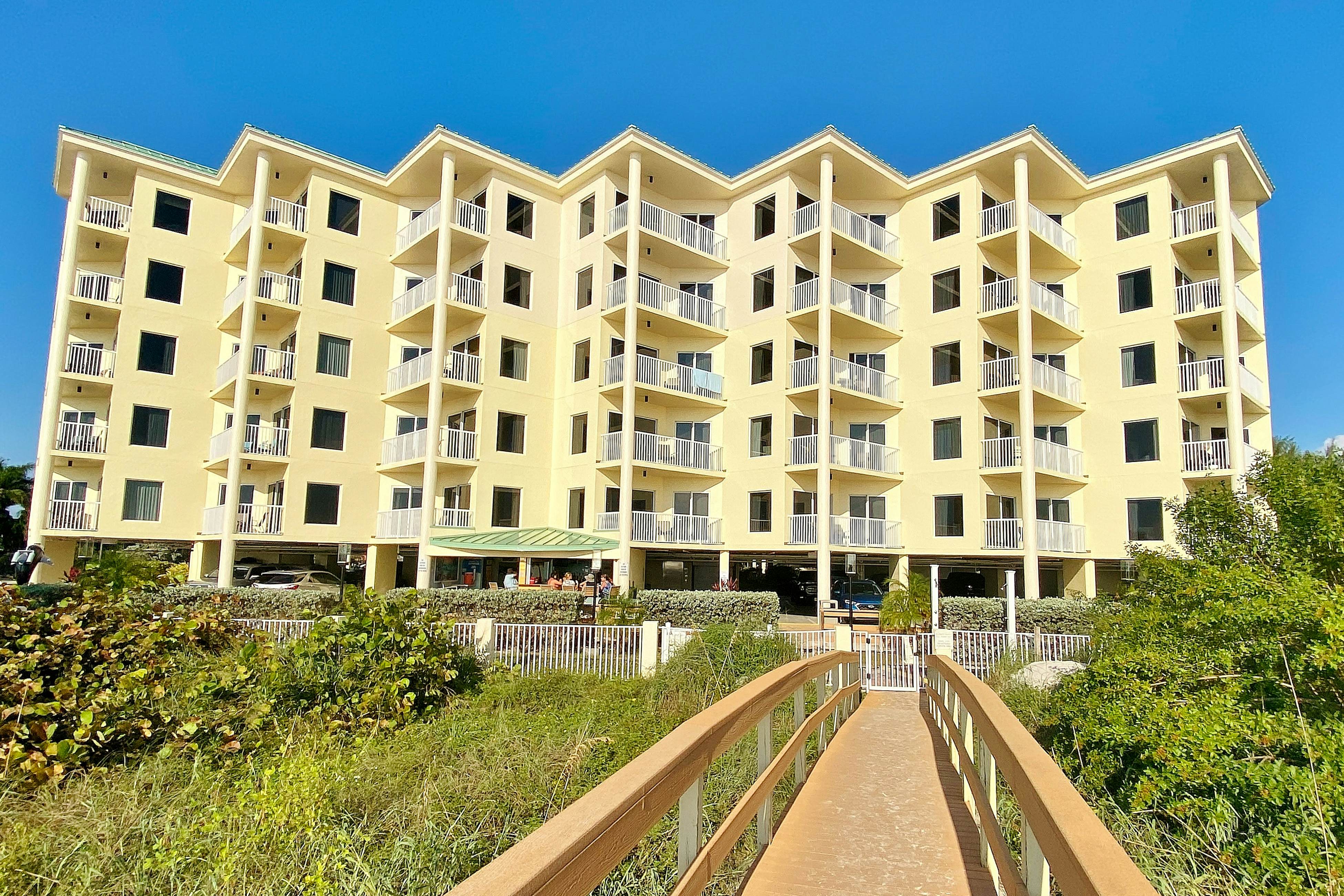 Second-floor condo with beach access, balcony, pool, hot tubs, and ping-pong