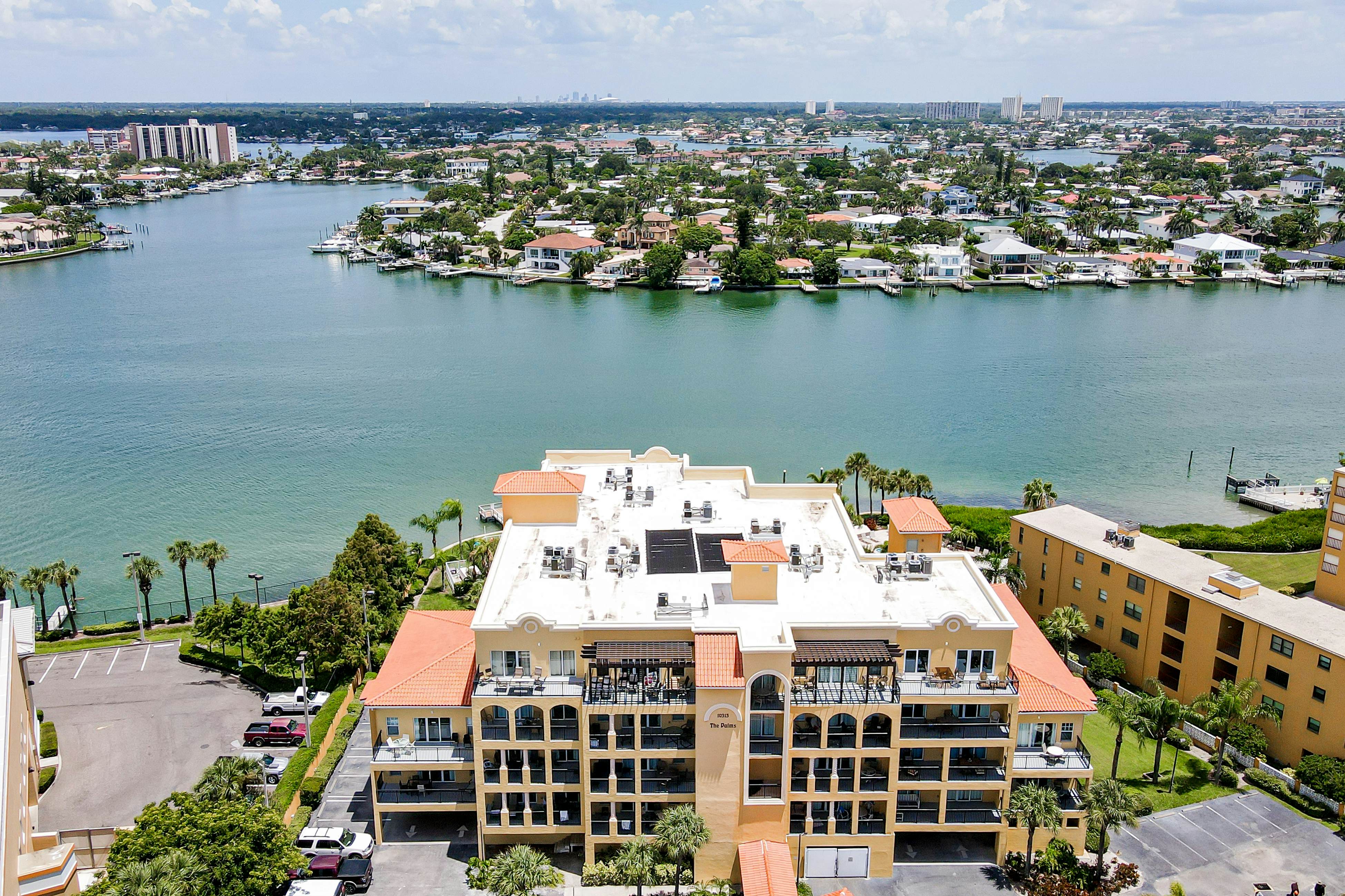 Water-view condo with pool, hot tub, pier, private balcony, AC, & washer/dryer