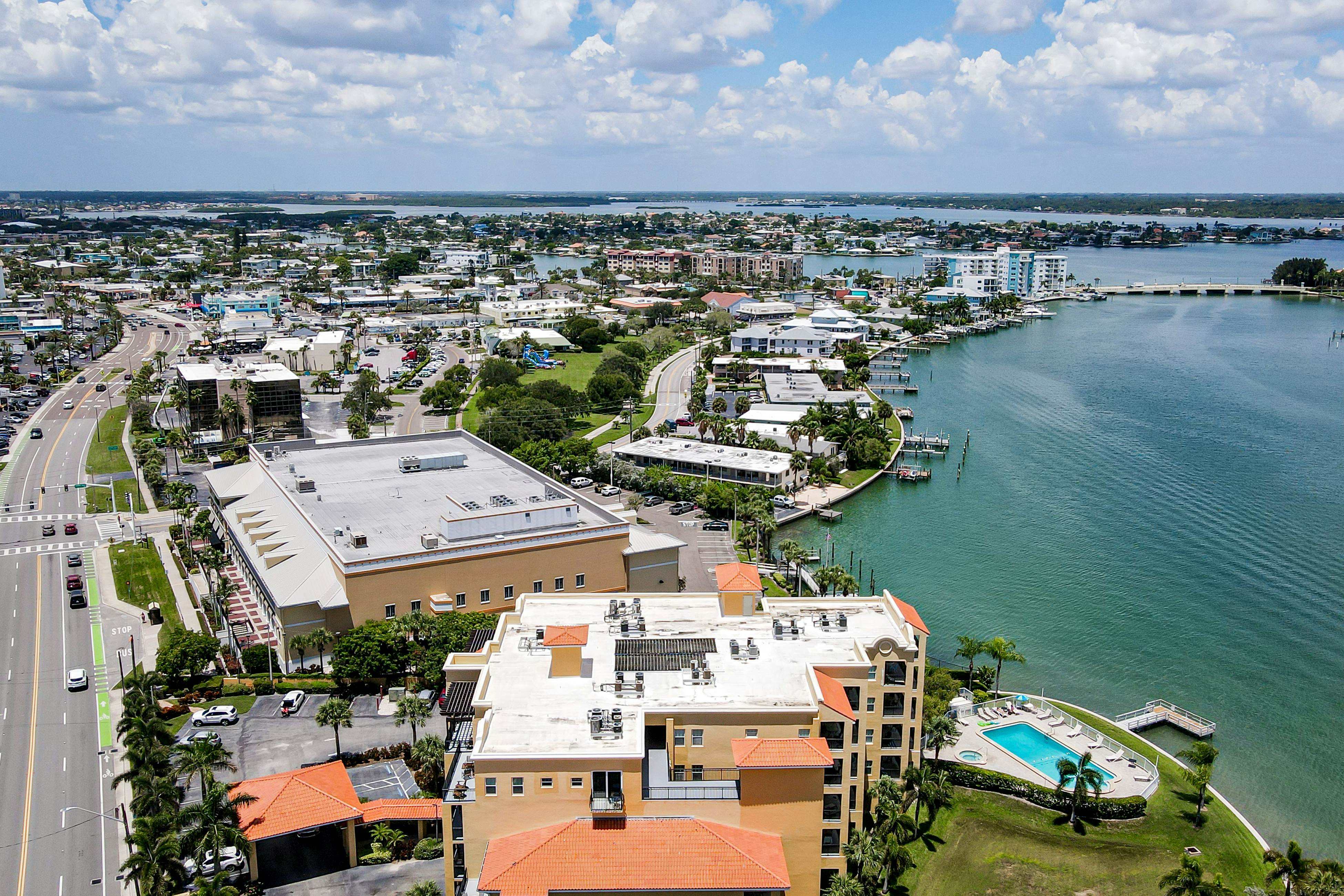 Water-view condo with pool, hot tub, pier, private balcony, AC, & washer/dryer