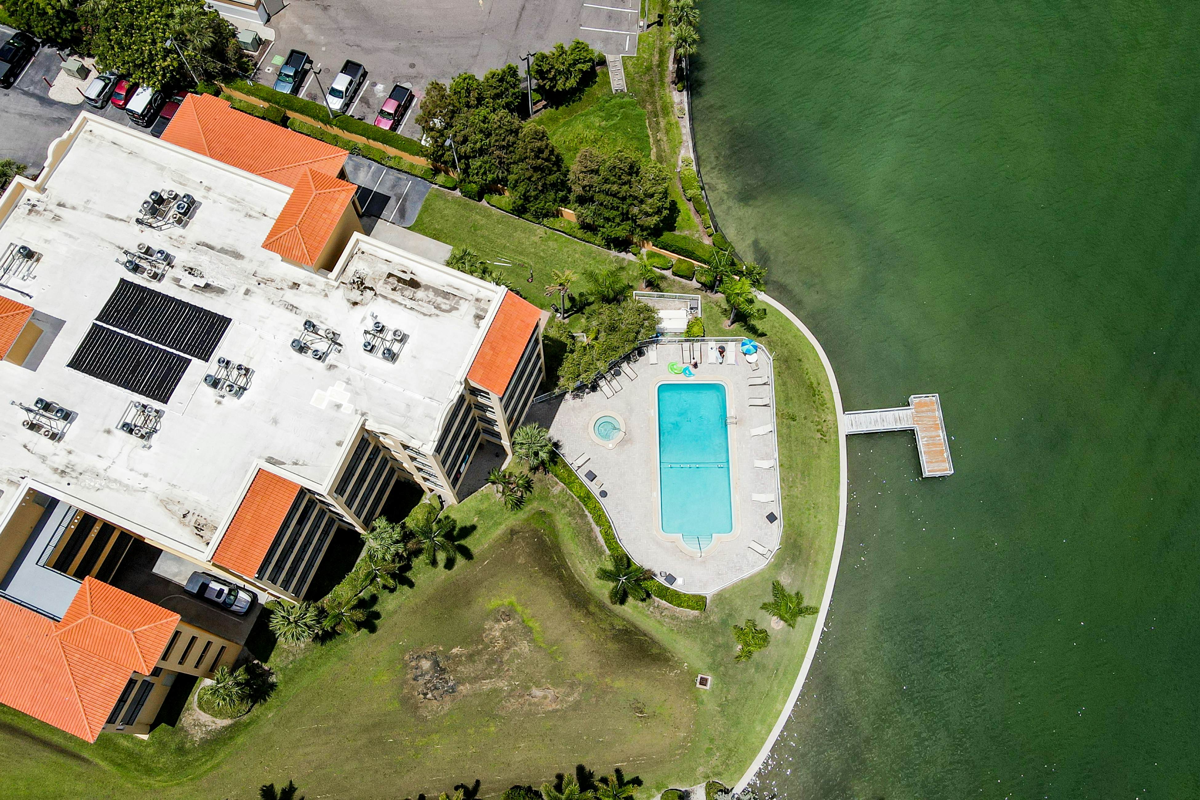 Water-view condo with pool, hot tub, pier, private balcony, AC, & washer/dryer