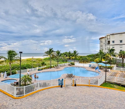 Beachfront and family friendly condo with two pools and hot tub steps to the Gulf