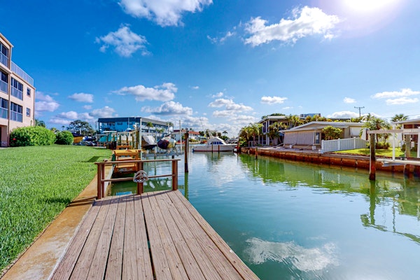 Canal front home near the beach with outdoor pool balcony water views and WD