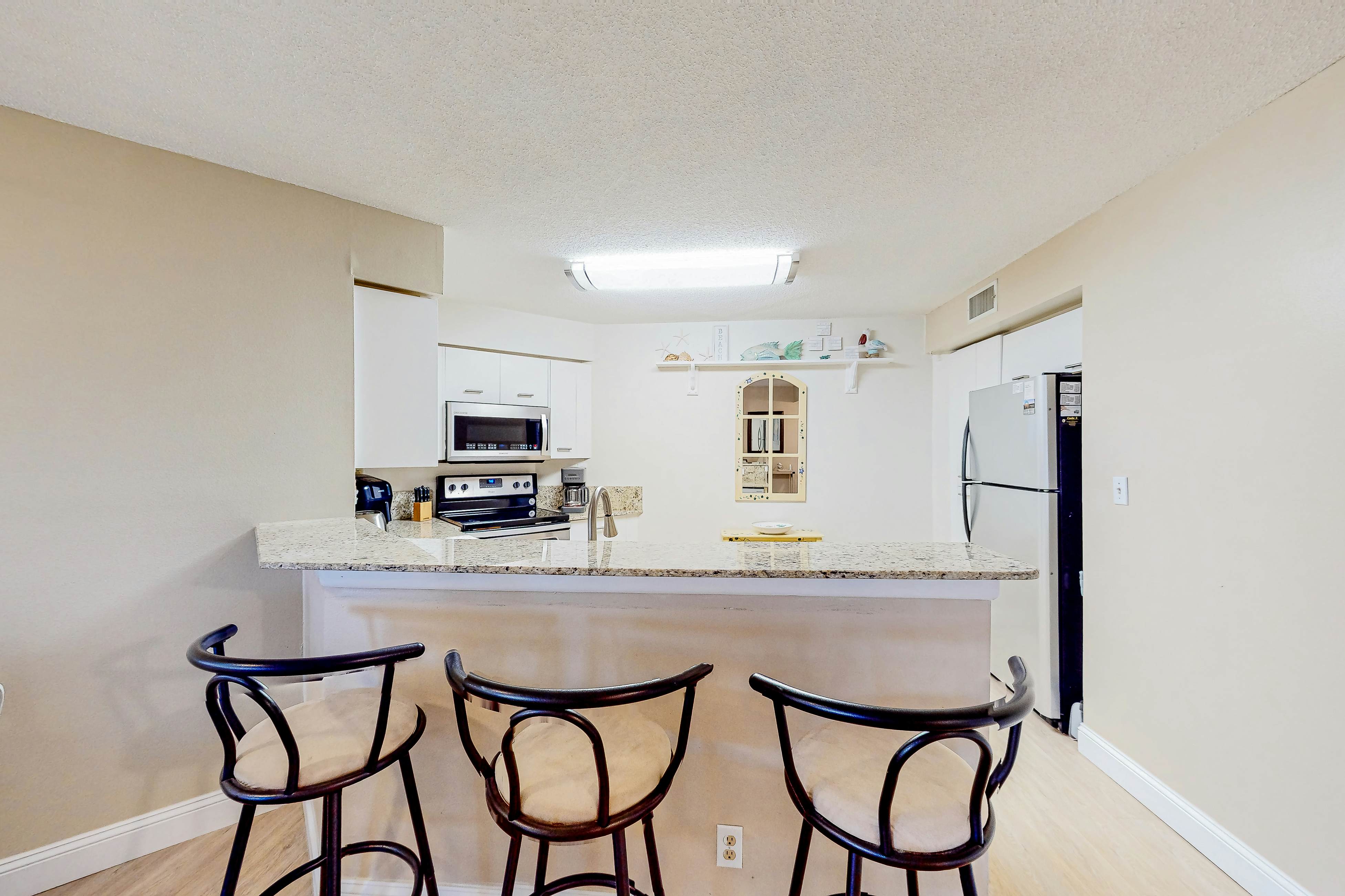 Ground-floor condo with golf course views, pool & beach access