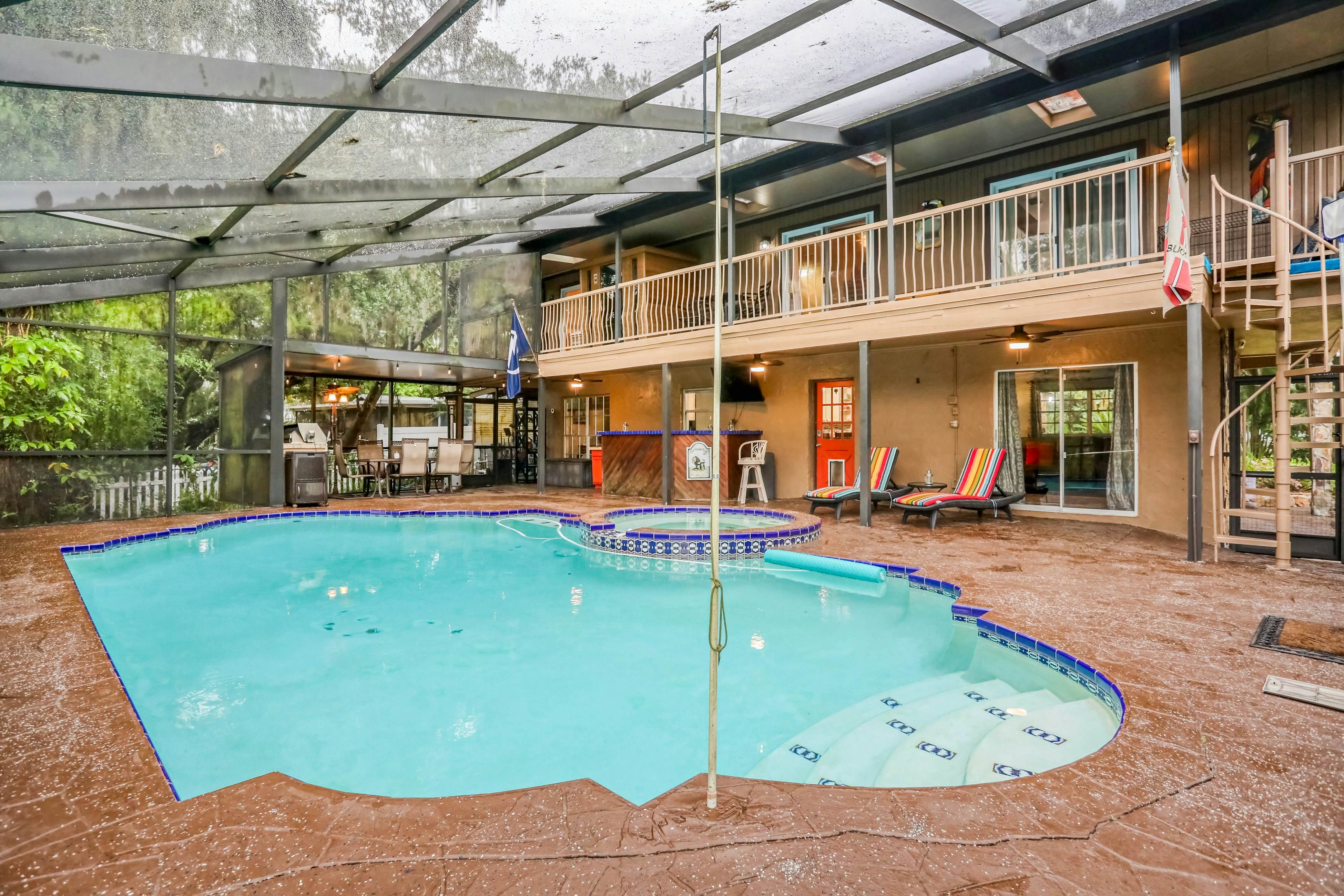 Riverfront retreat with pool/spa, outdoor kitchen, firepit, dock, sauna & games