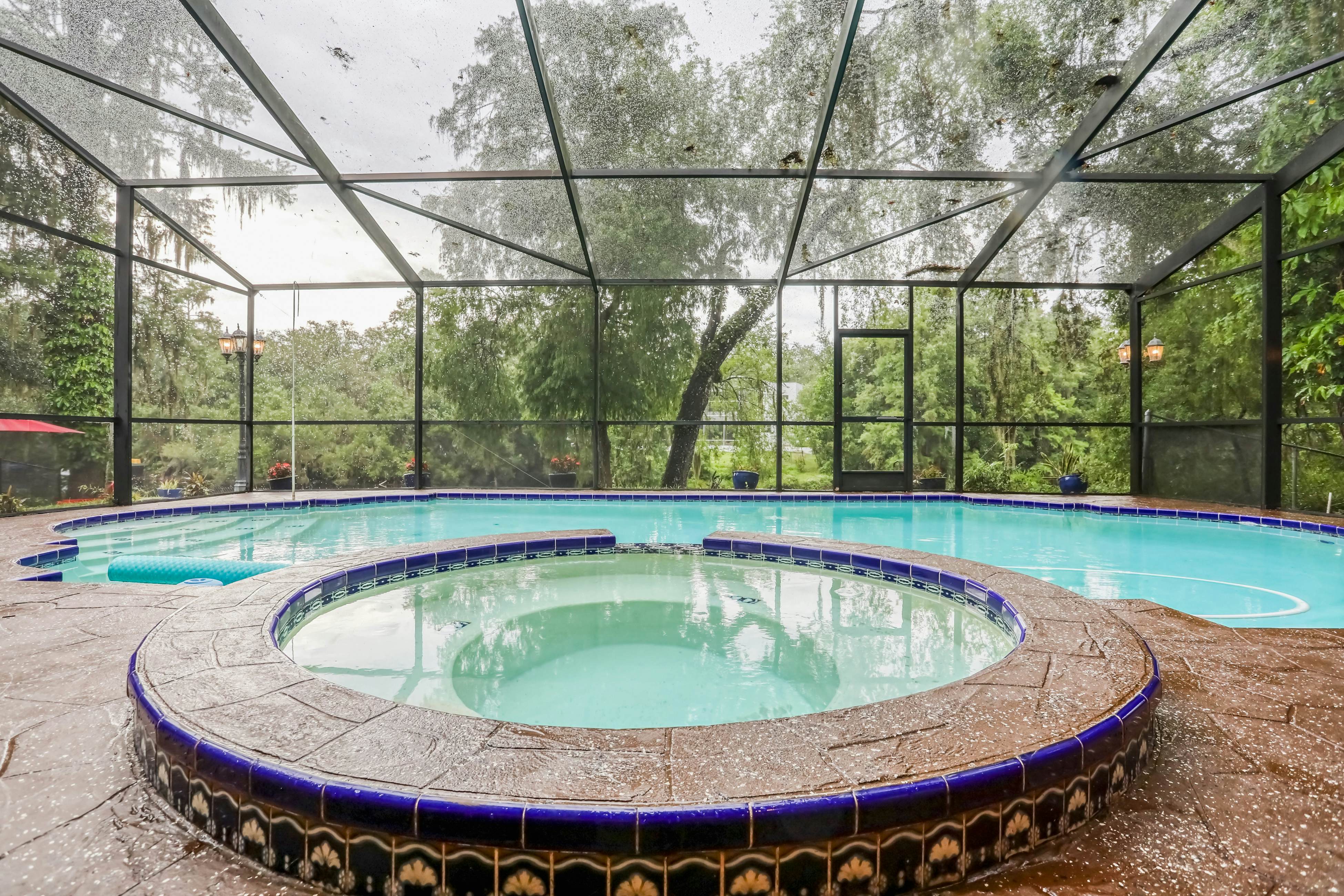 Riverfront retreat with pool/spa, outdoor kitchen, firepit, dock, sauna & games