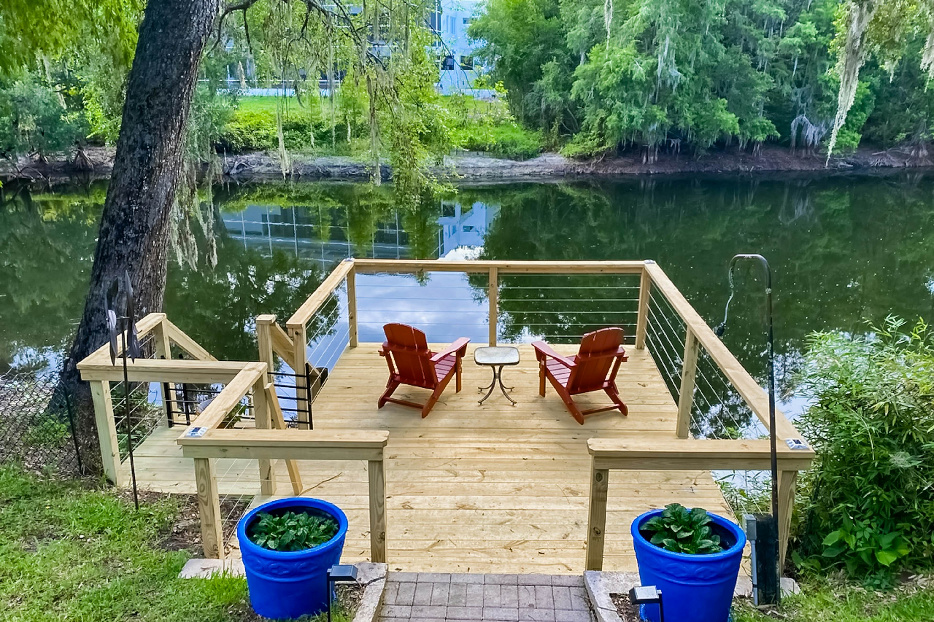 Riverfront retreat with pool/spa, outdoor kitchen, firepit, dock, sauna & games