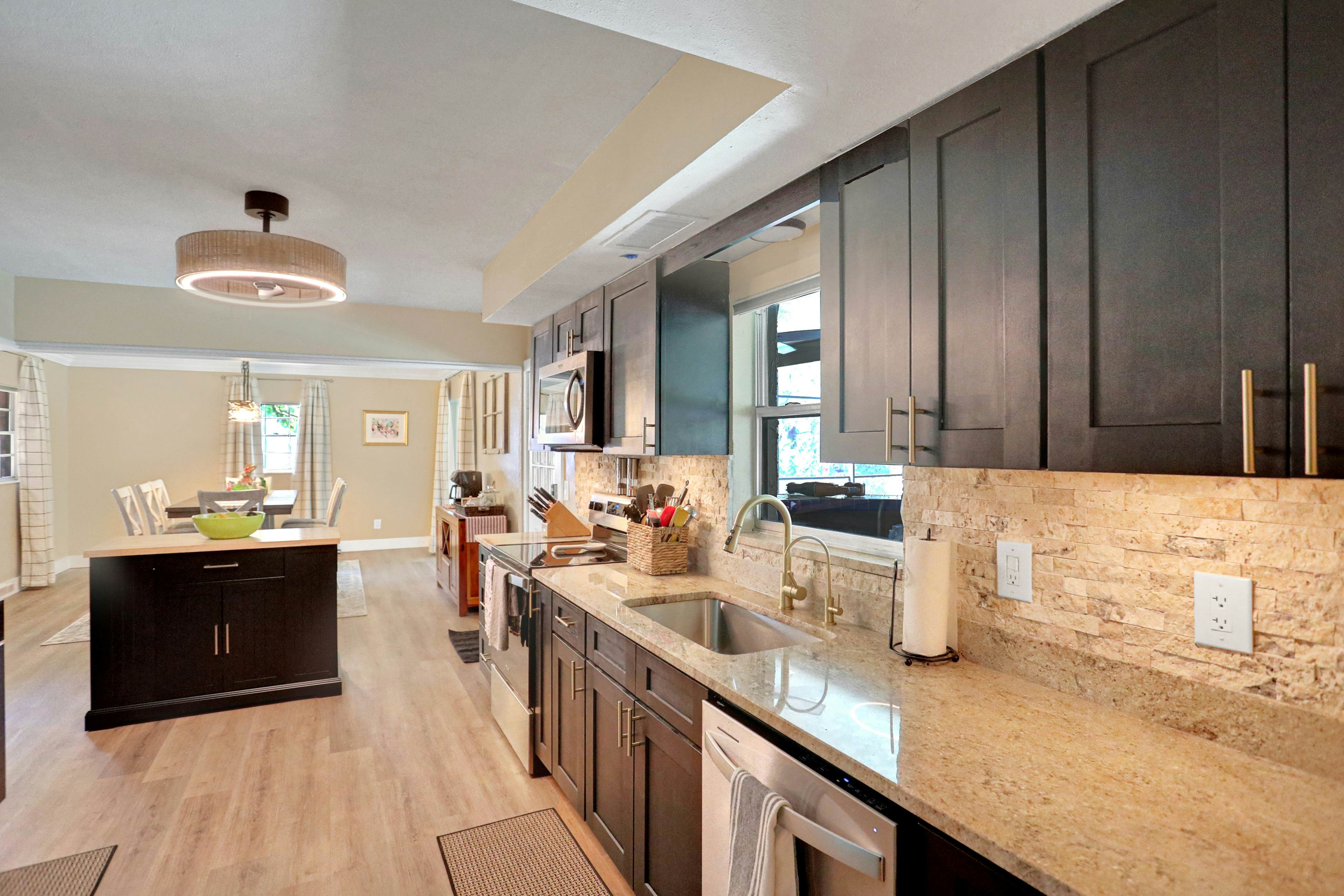 Riverfront retreat with pool/spa, outdoor kitchen, firepit, dock, sauna & games