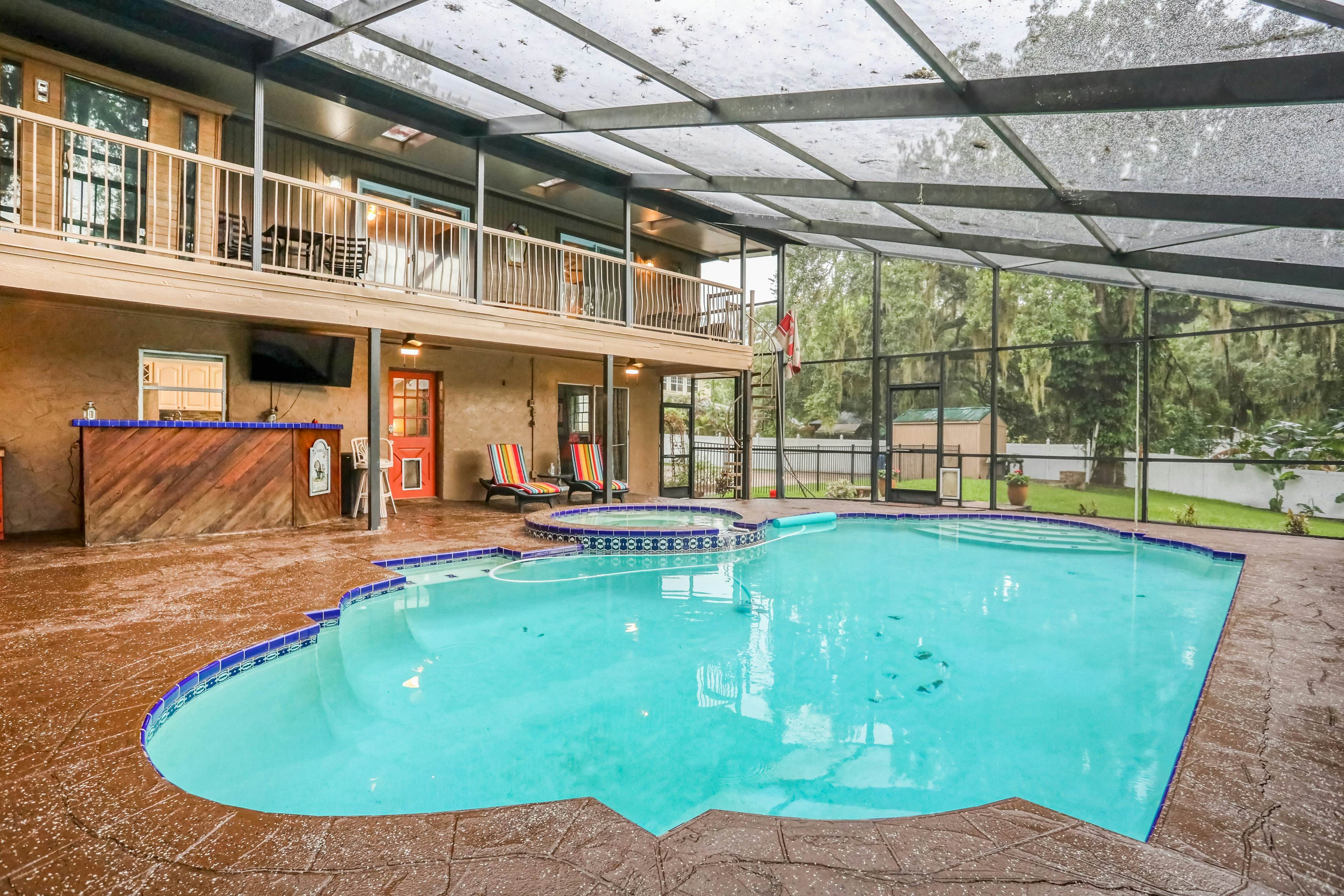 Riverfront retreat with pool/spa, outdoor kitchen, firepit, dock, sauna & games