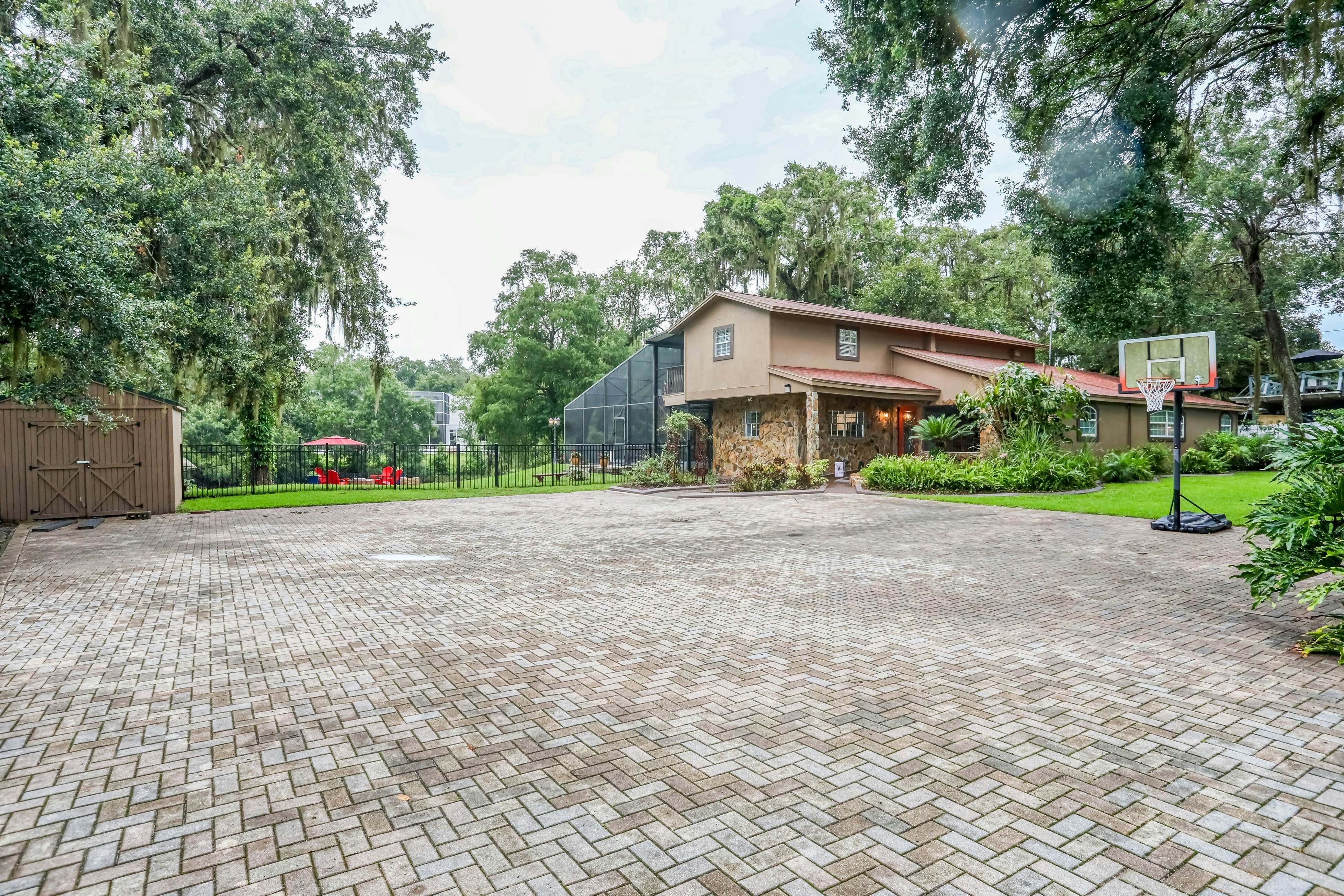 Riverfront retreat with pool/spa, outdoor kitchen, firepit, dock, sauna & games