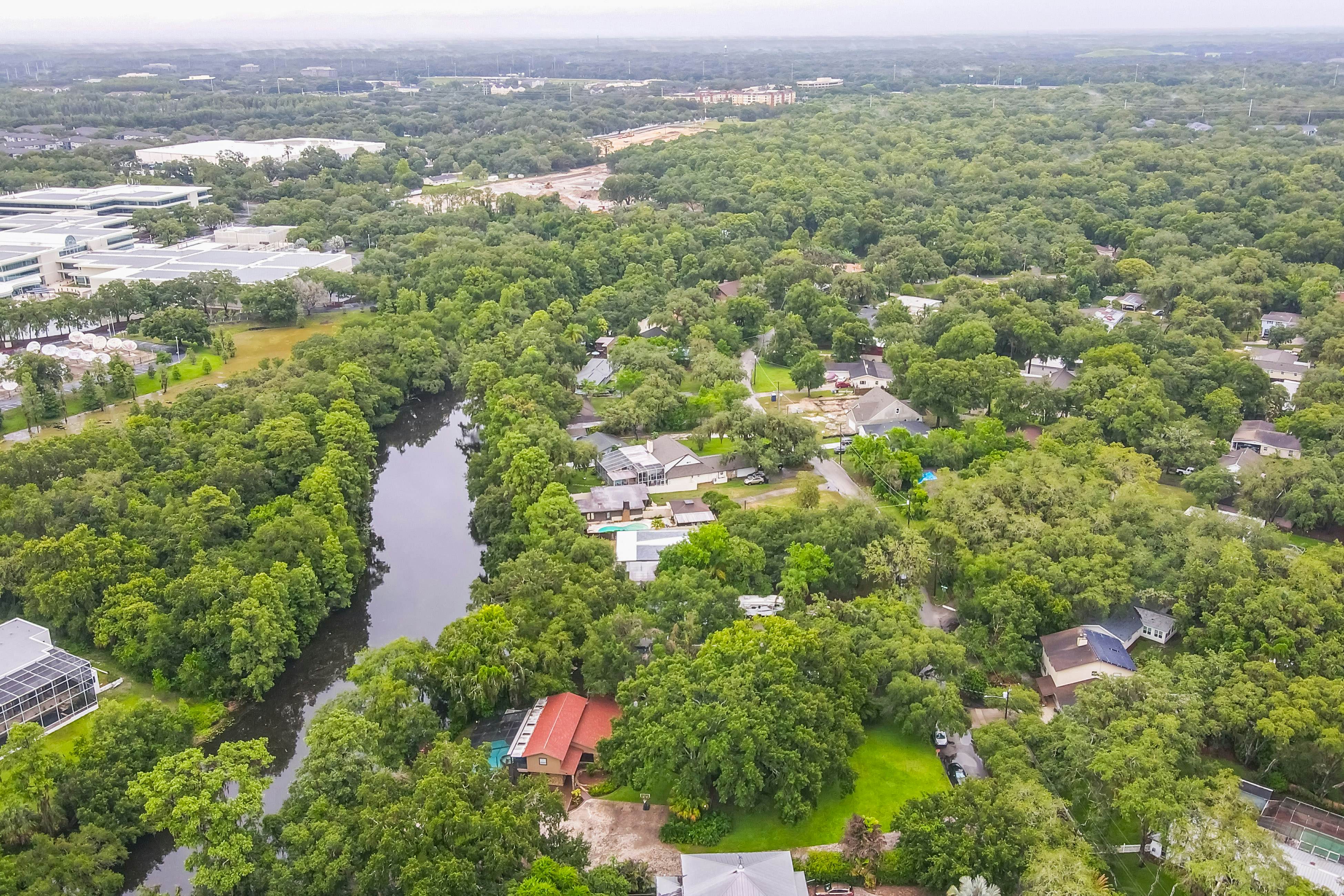 Riverfront retreat with pool/spa, outdoor kitchen, firepit, dock, sauna & games