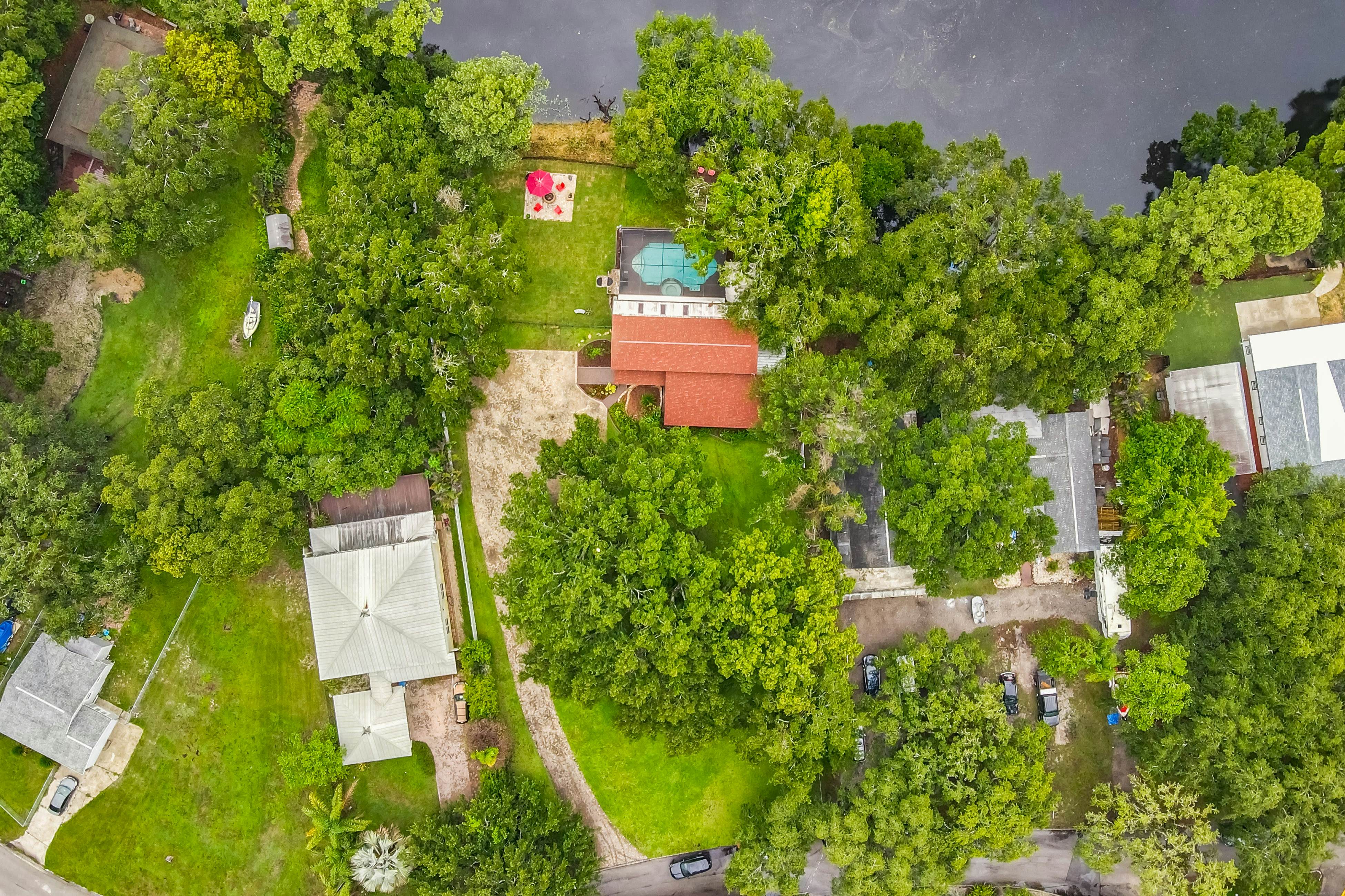 Riverfront retreat with pool/spa, outdoor kitchen, firepit, dock, sauna & games