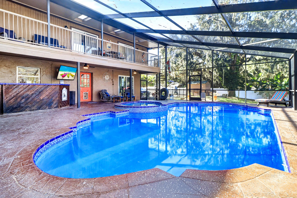 Riverfront retreat with pool spa outdoor kitchen firepit dock sauna and games