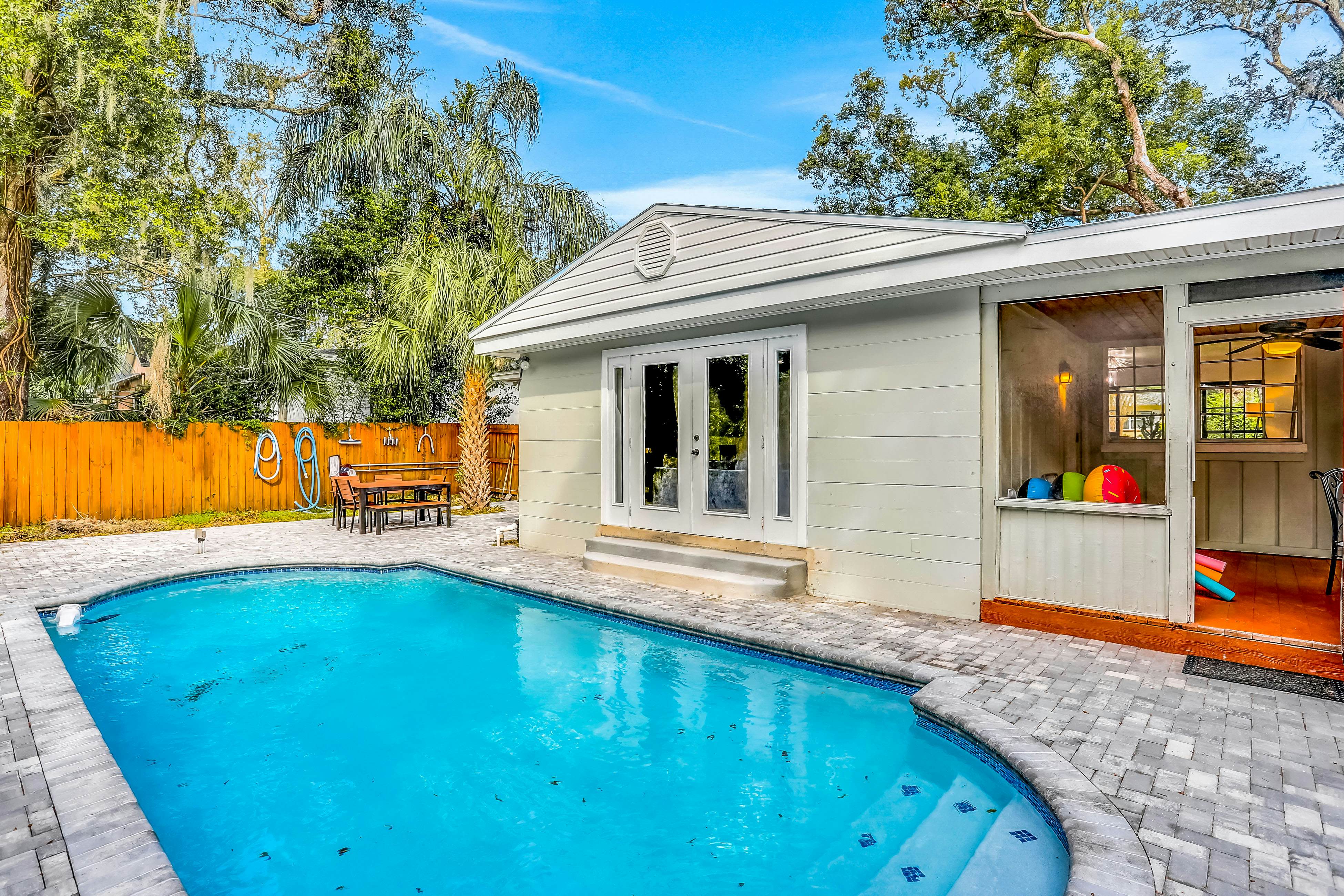 Single-level home with pool, fenced yard, & screened porch + a neighborhood park