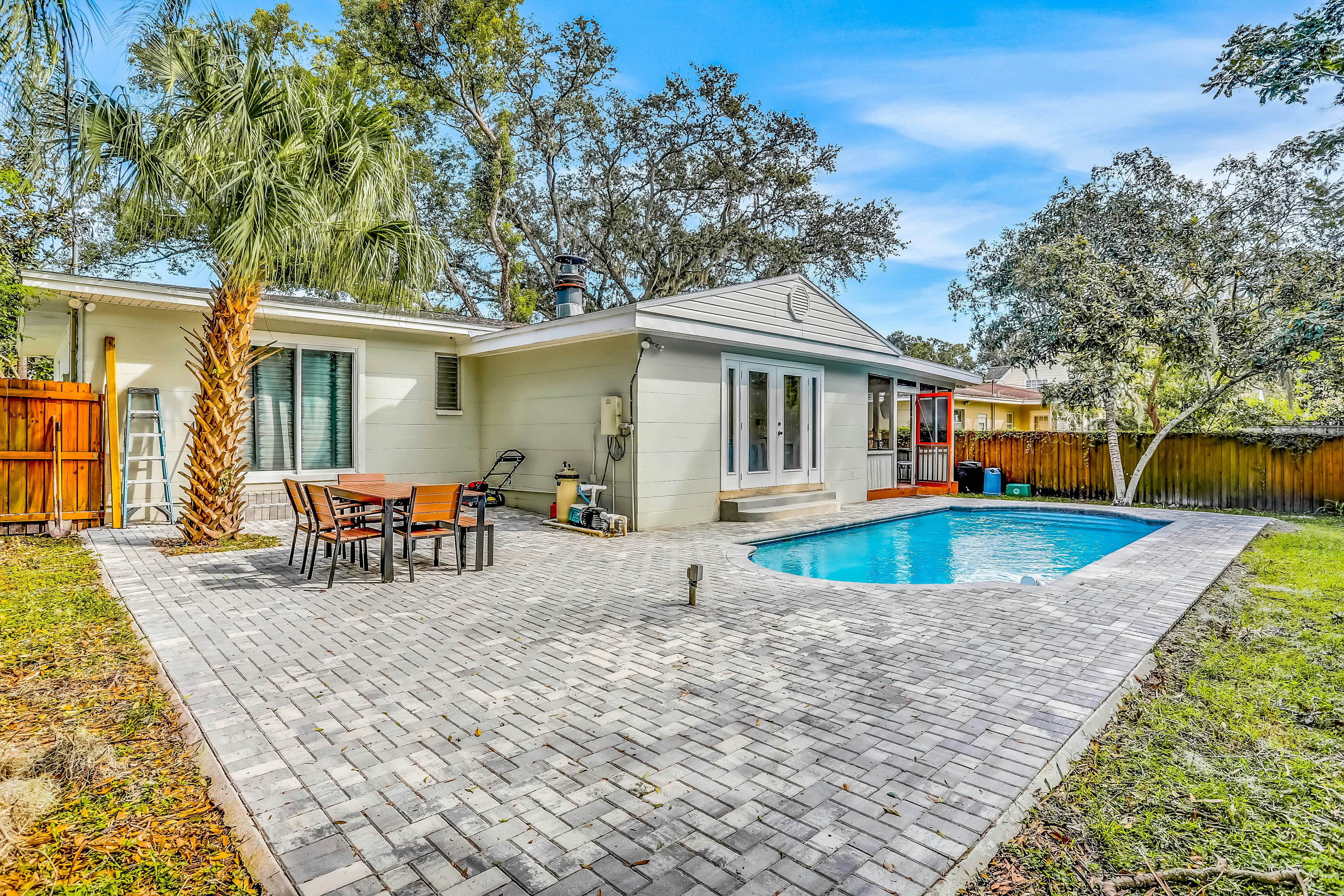 Single-level home with pool, fenced yard, & screened porch + a neighborhood park