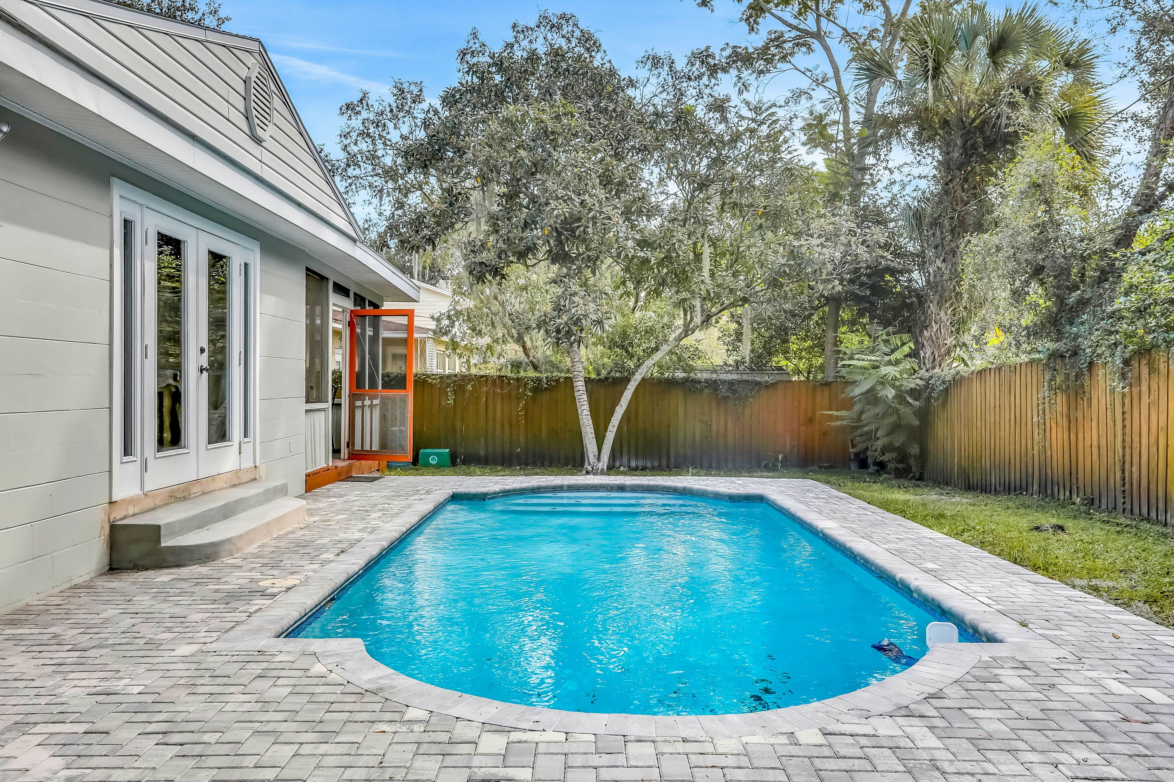 Single-level home with pool, fenced yard, & screened porch + a neighborhood park