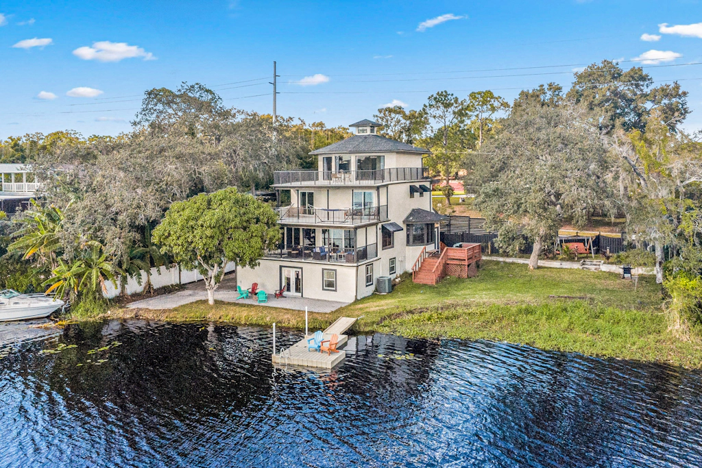 Sprawling river view estate with game room dock kayaks grill and fishing gear