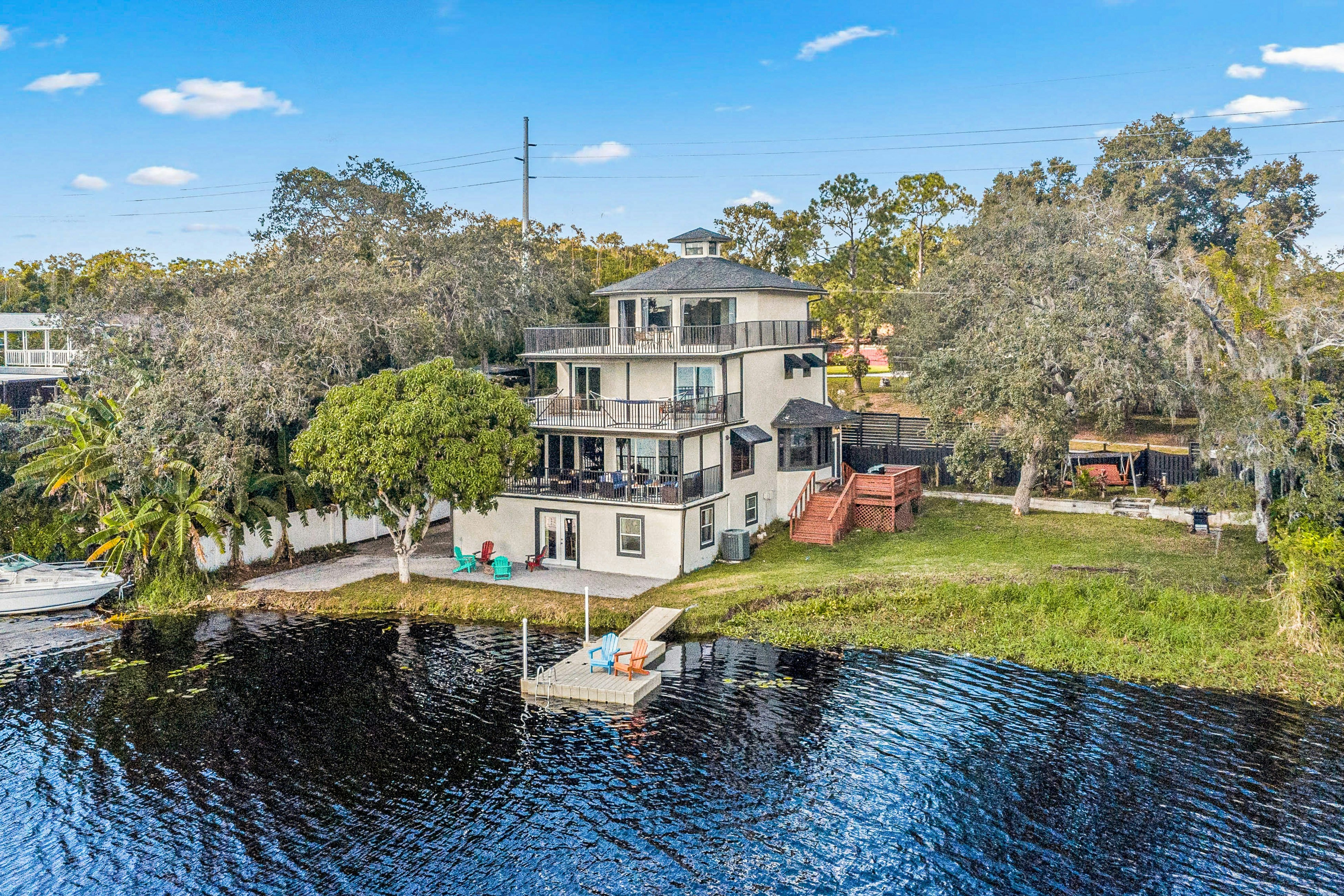 Sprawling river view estate with game room, dock, kayaks, grill, & fishing gear