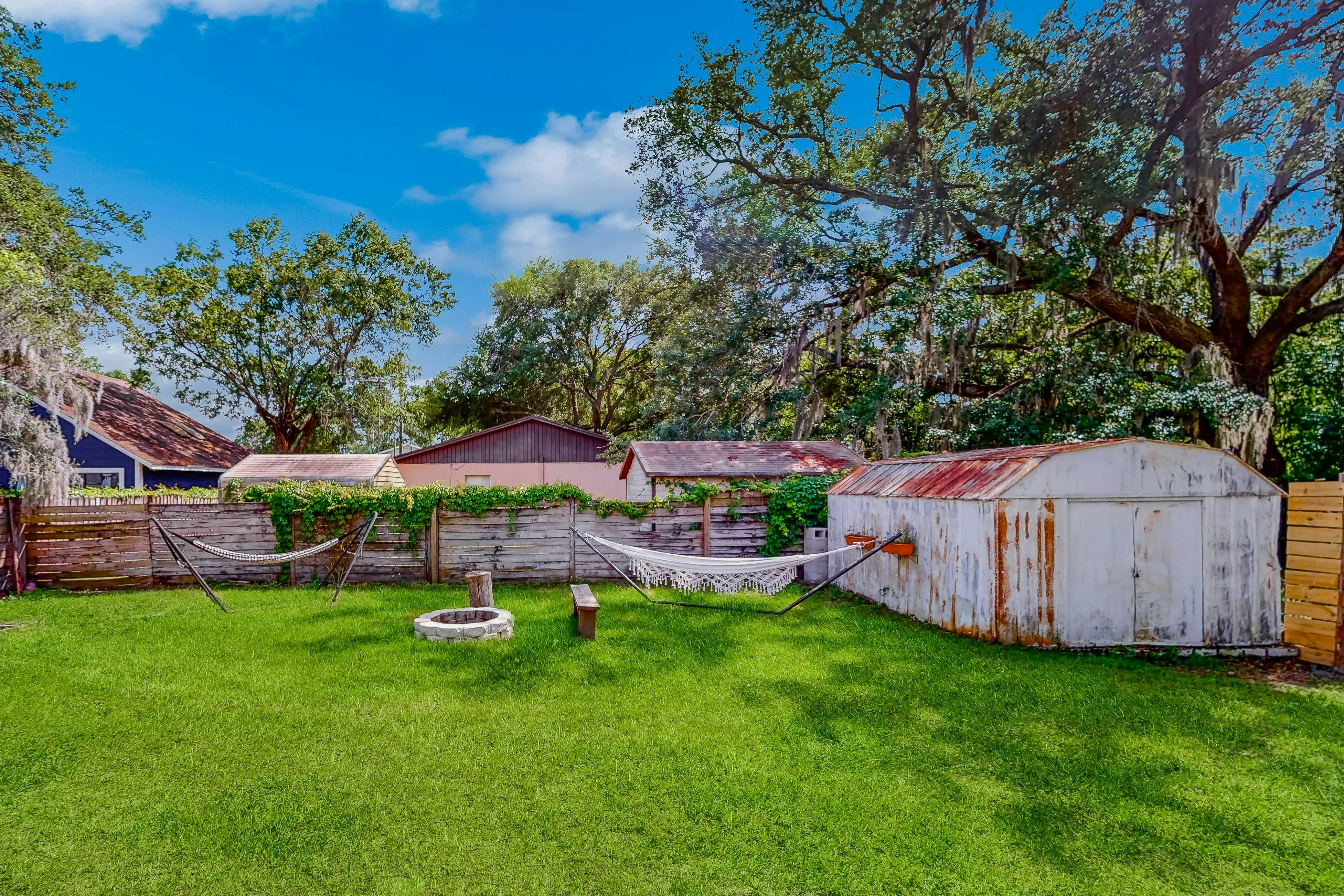 Dog-friendly home with fenced yard, firepit, washer/dryer, & central AC