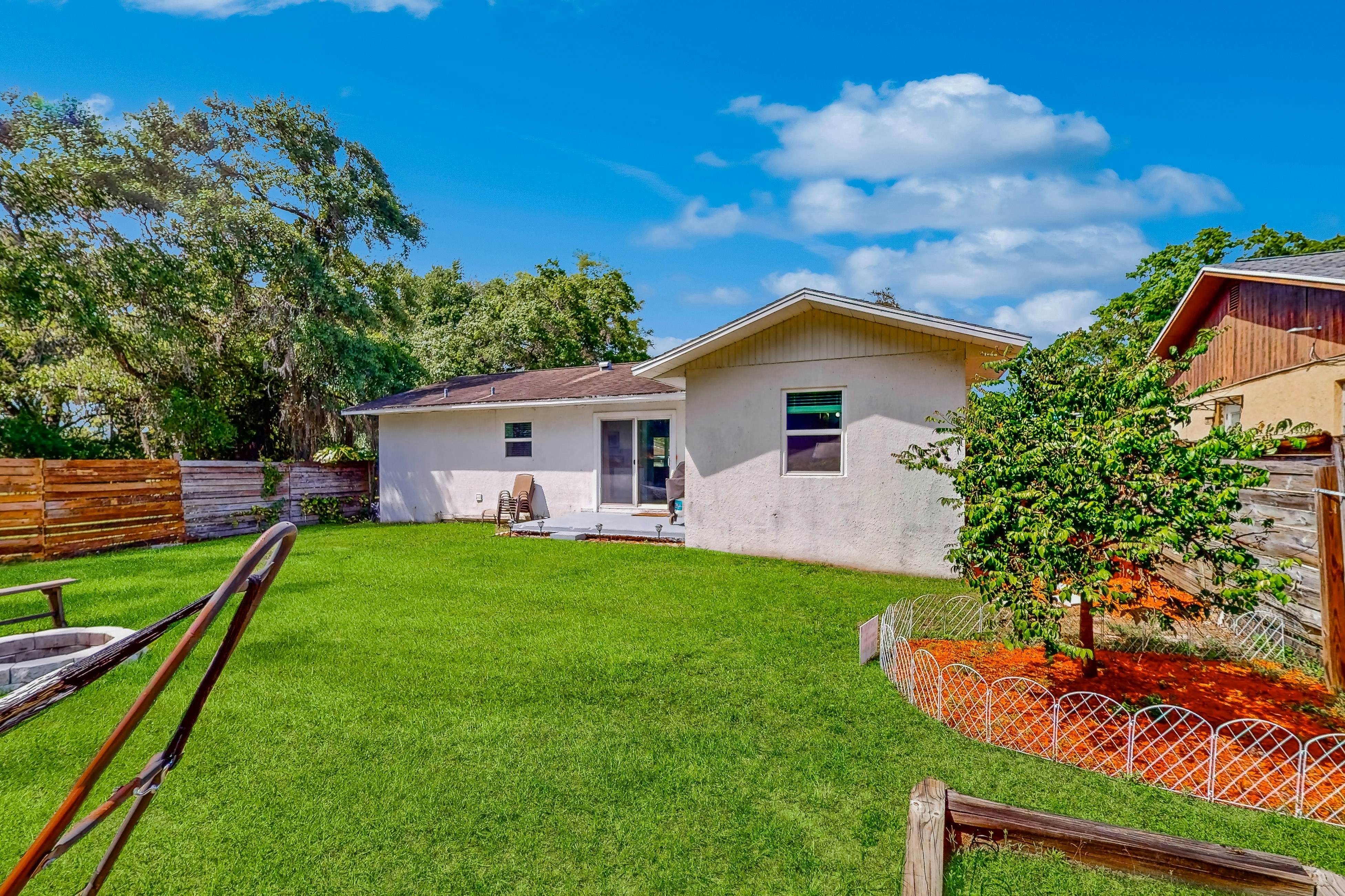 Dog-friendly home with fenced yard, firepit, washer/dryer, & central AC