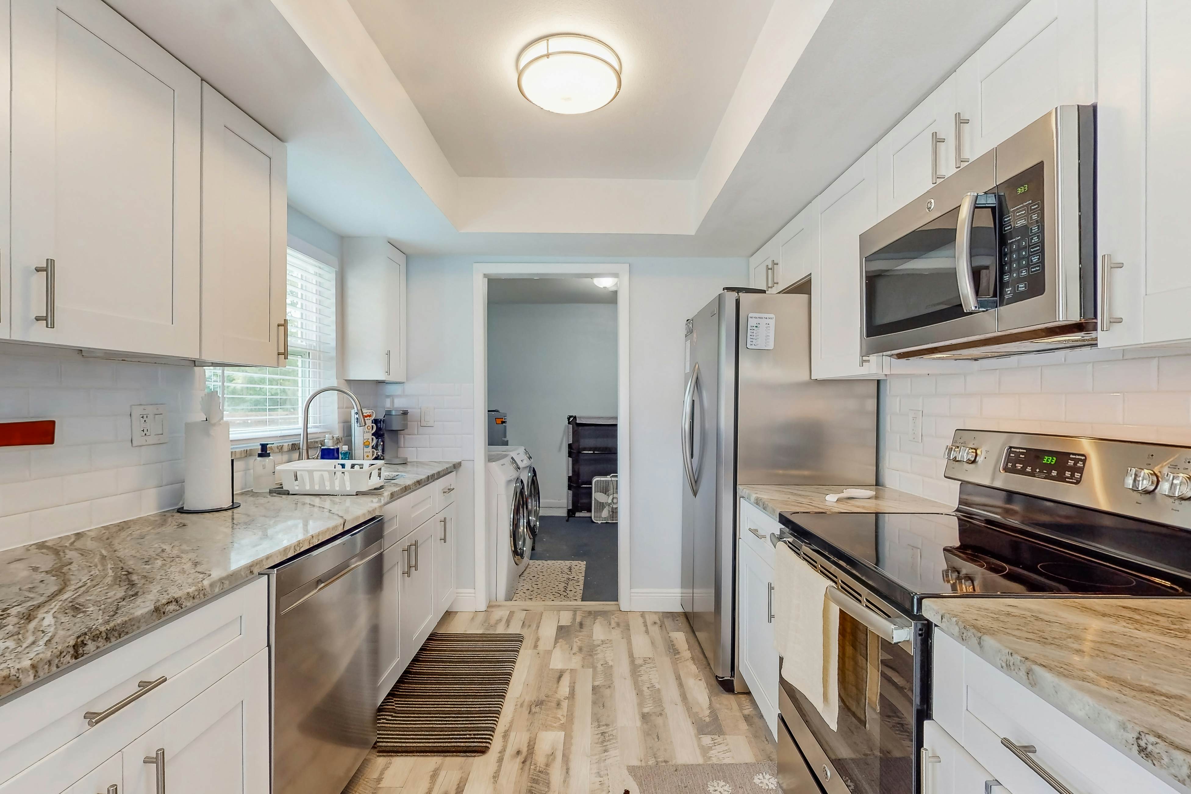 Dog-friendly home with fenced yard, firepit, washer/dryer, & central AC