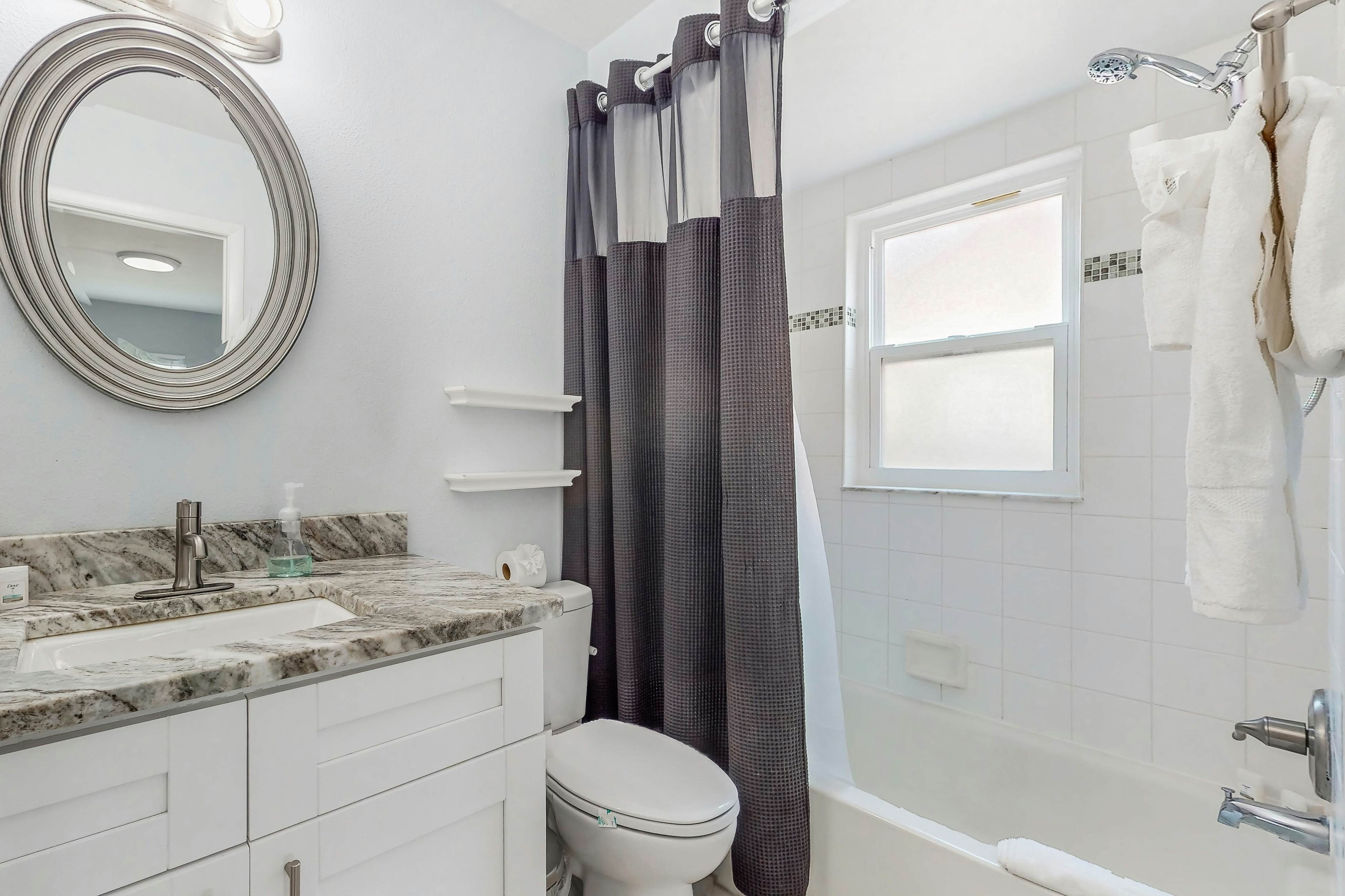 Dog-friendly home with fenced yard, firepit, washer/dryer, & central AC