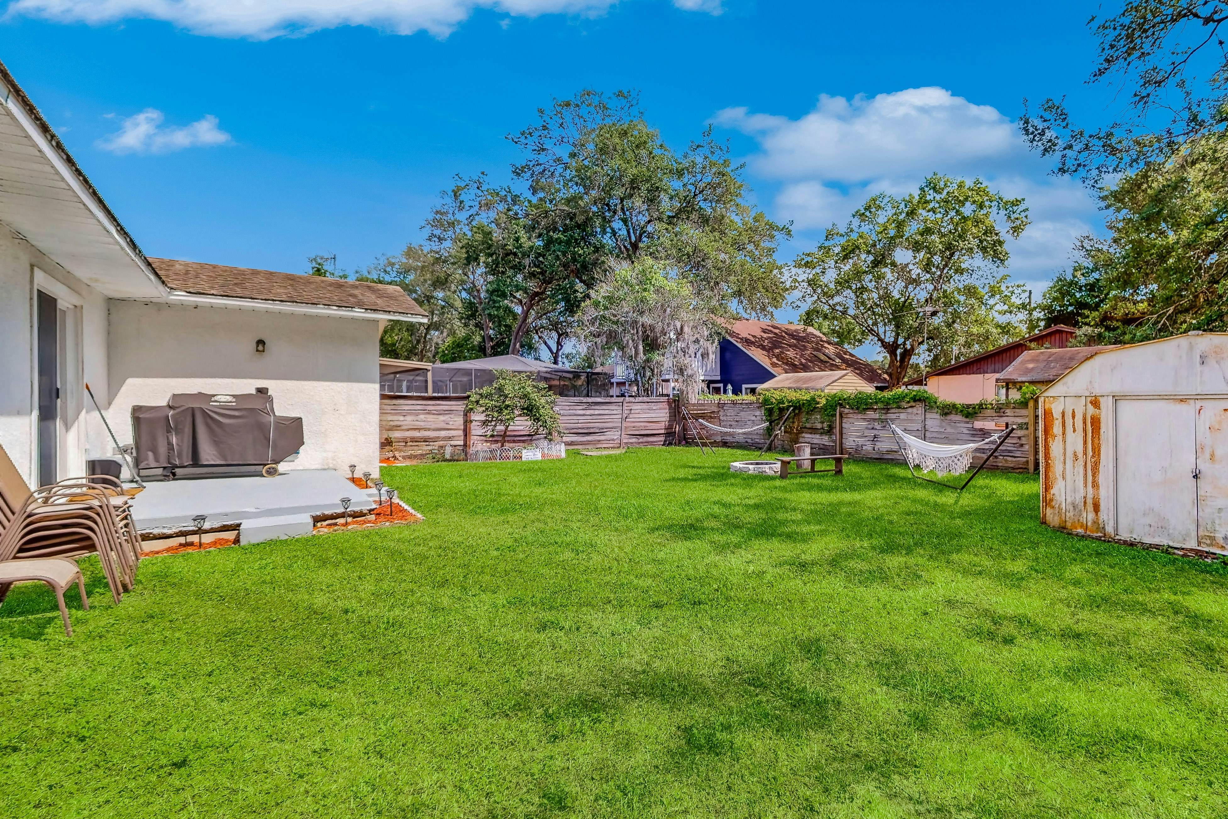 Dog-friendly home with fenced yard, firepit, washer/dryer, & central AC