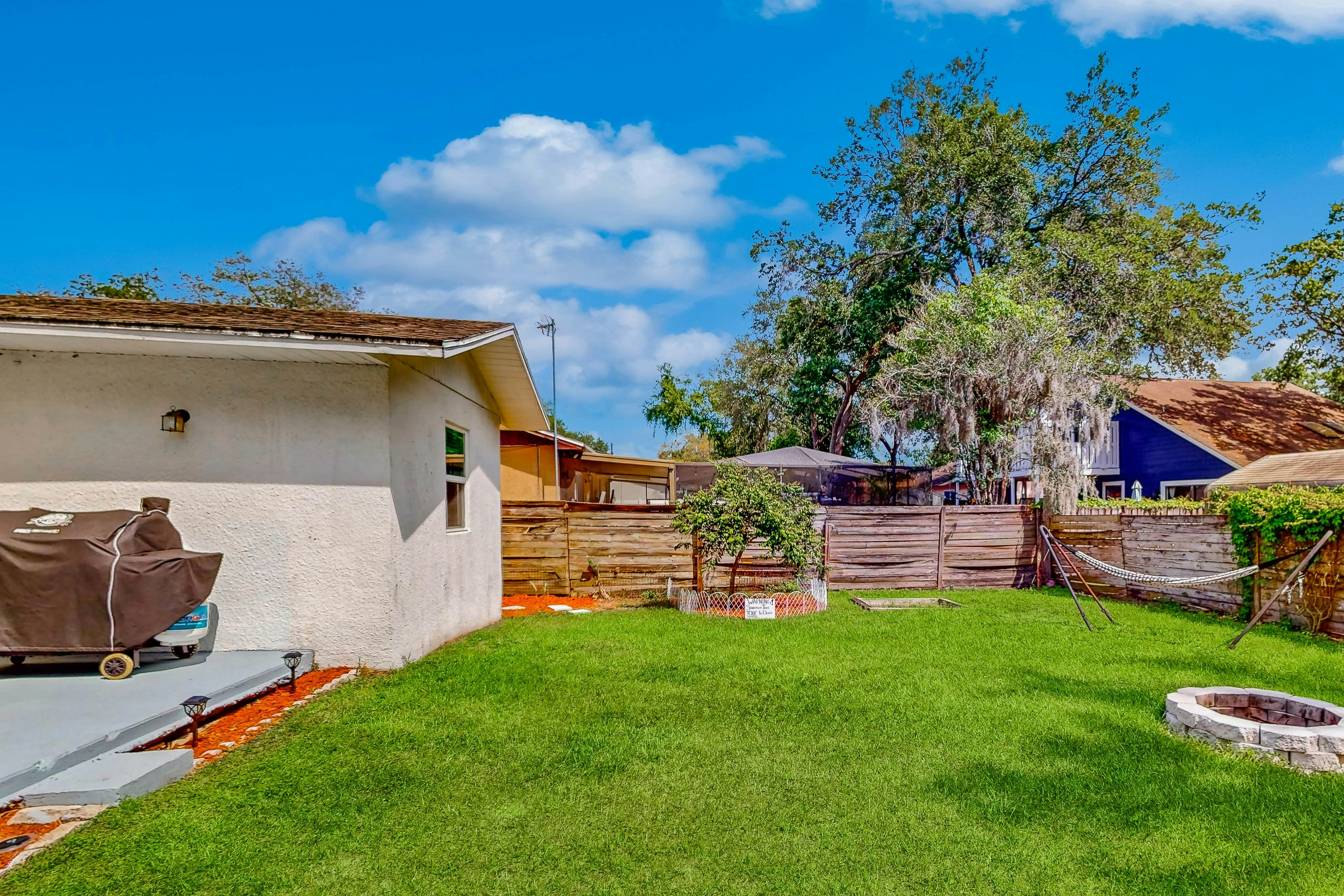 Dog-friendly home with fenced yard, firepit, washer/dryer, & central AC