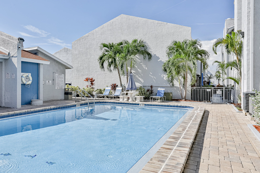 Water view condo with balcony heated pool and WD walk to beach