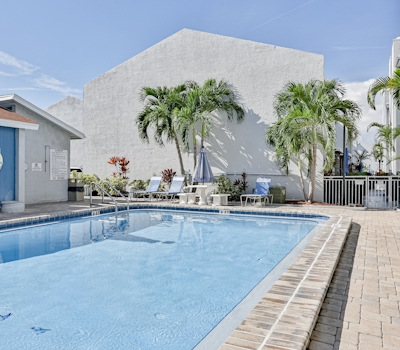 Water view condo with balcony heated pool and WD walk to beach