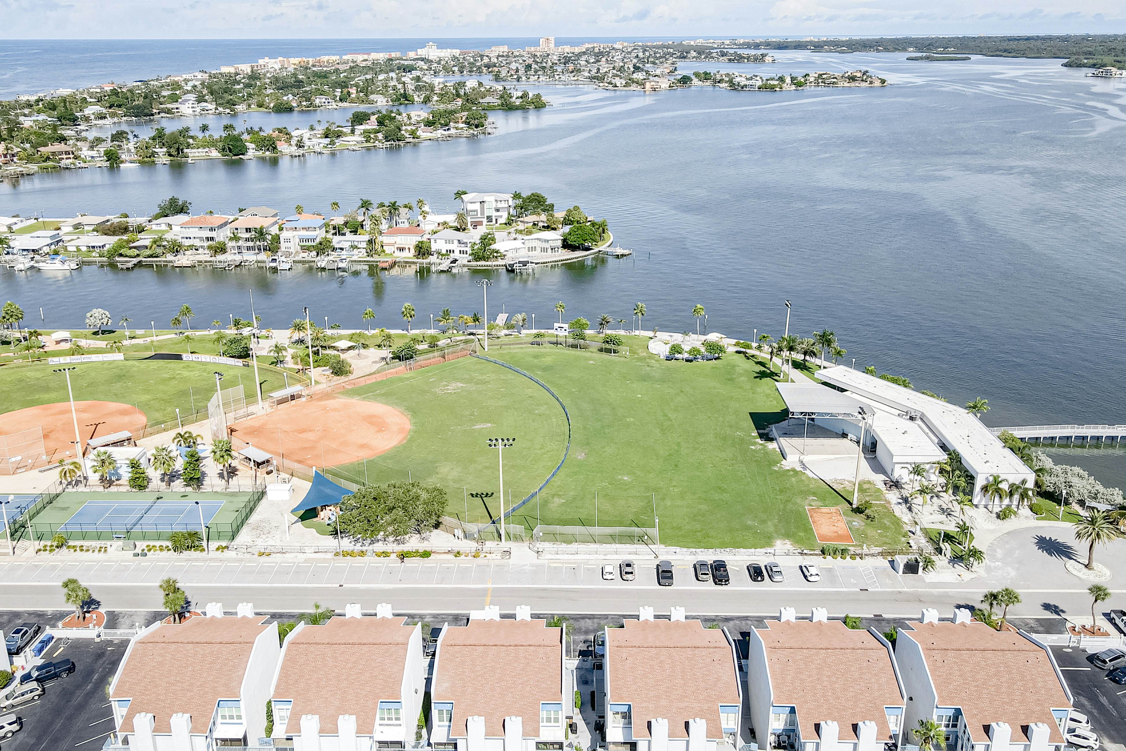 Water-view condo with balcony, pool & W/D - walk to beach