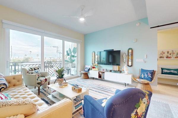 Sunlit and colorful beach condo with heated pool hot tub and balcony near shore and shops
