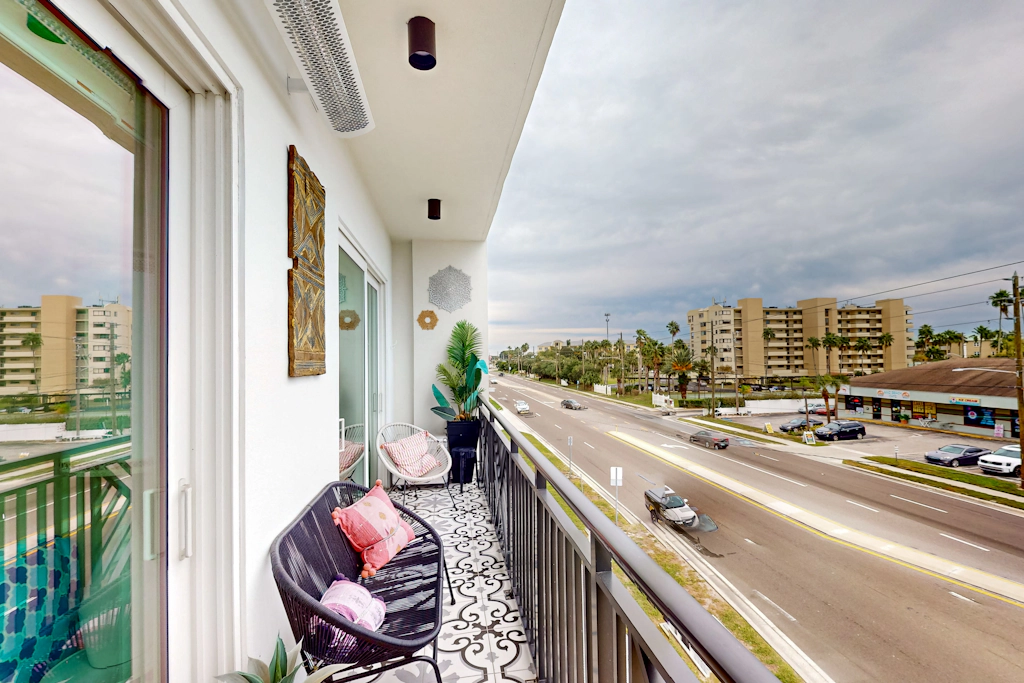 Sunlit and colorful beach condo with heated pool hot tub and balcony near shore and shops
