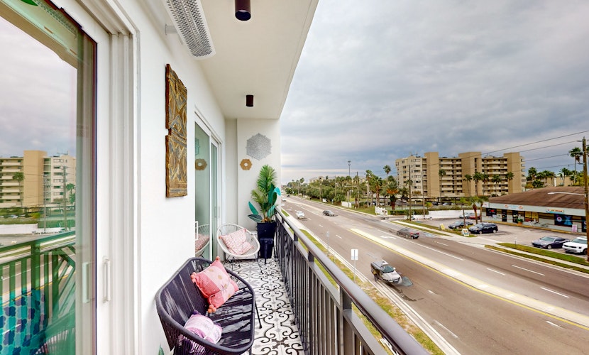 Sunlit and colorful beach condo with heated pool hot tub and balcony near shore and shops