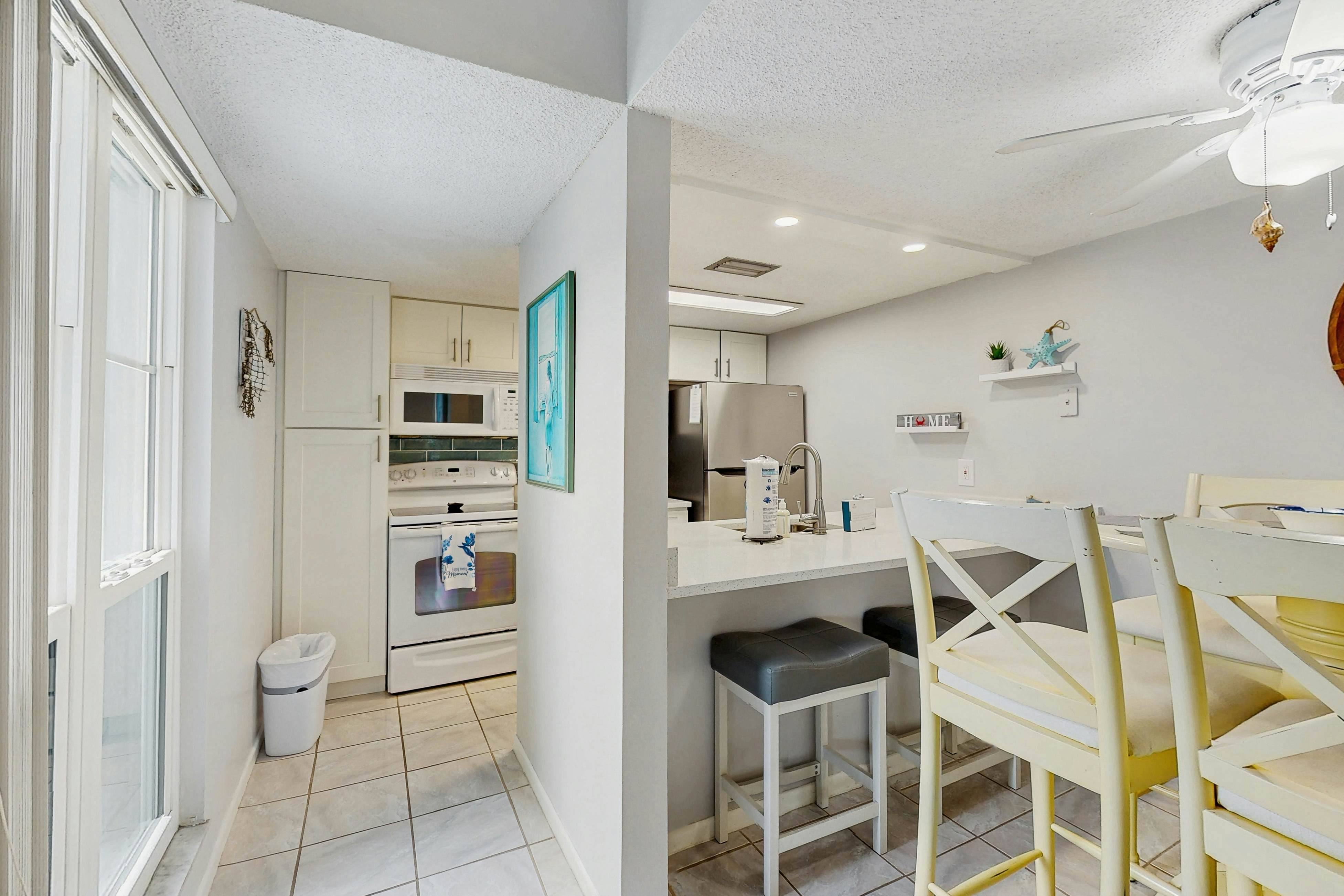 Water-view condo with balcony, grill, heated pool, hot tub, & sauna - walk to beach