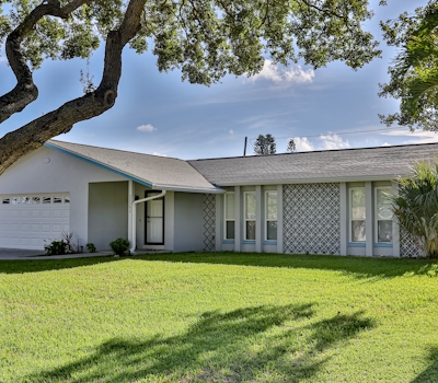 Modern coastal getaway with pool enclosed yard grill and outdoor bar