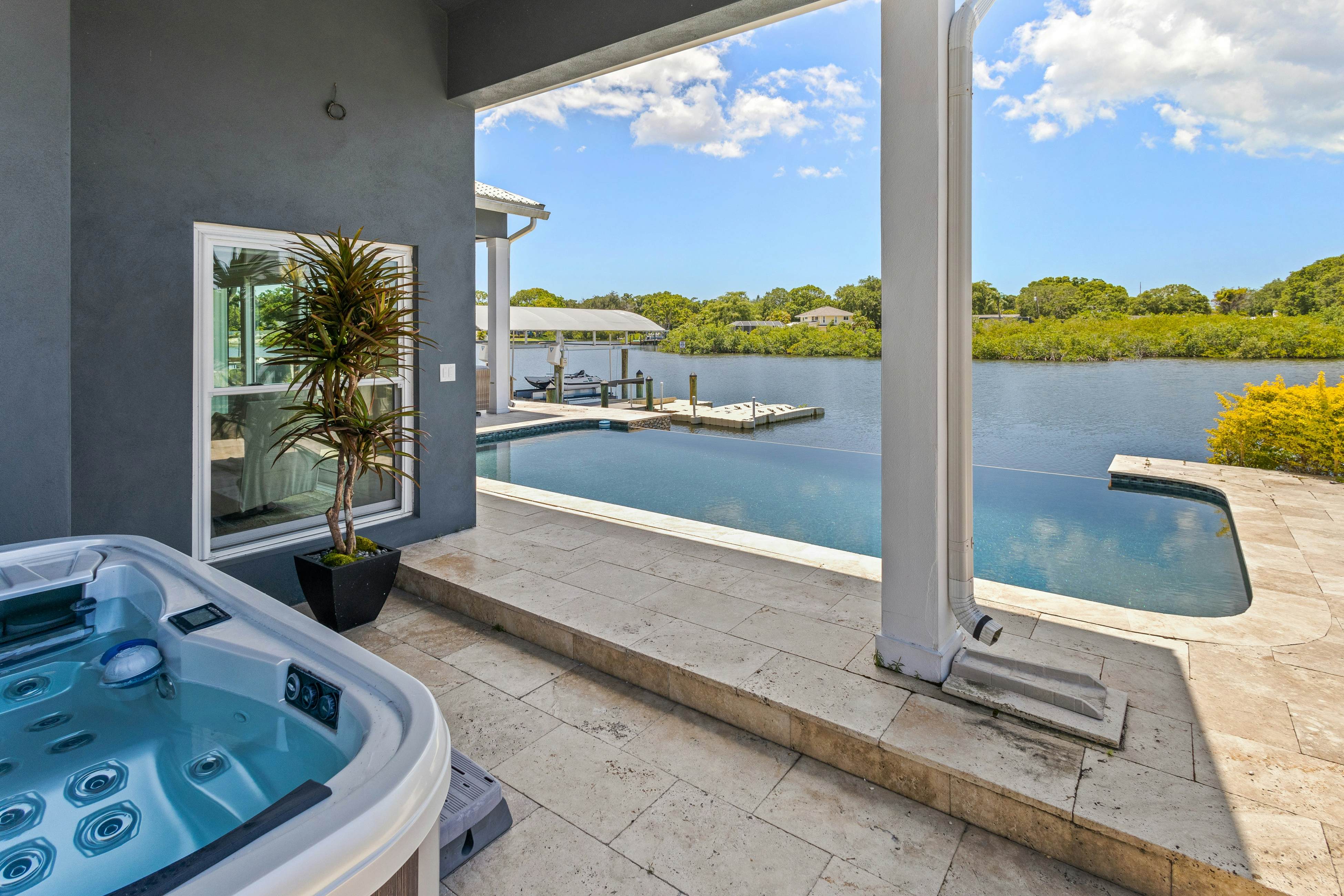 Modern indulgence with media room, expansive waterway views, AC, WD and Wifi