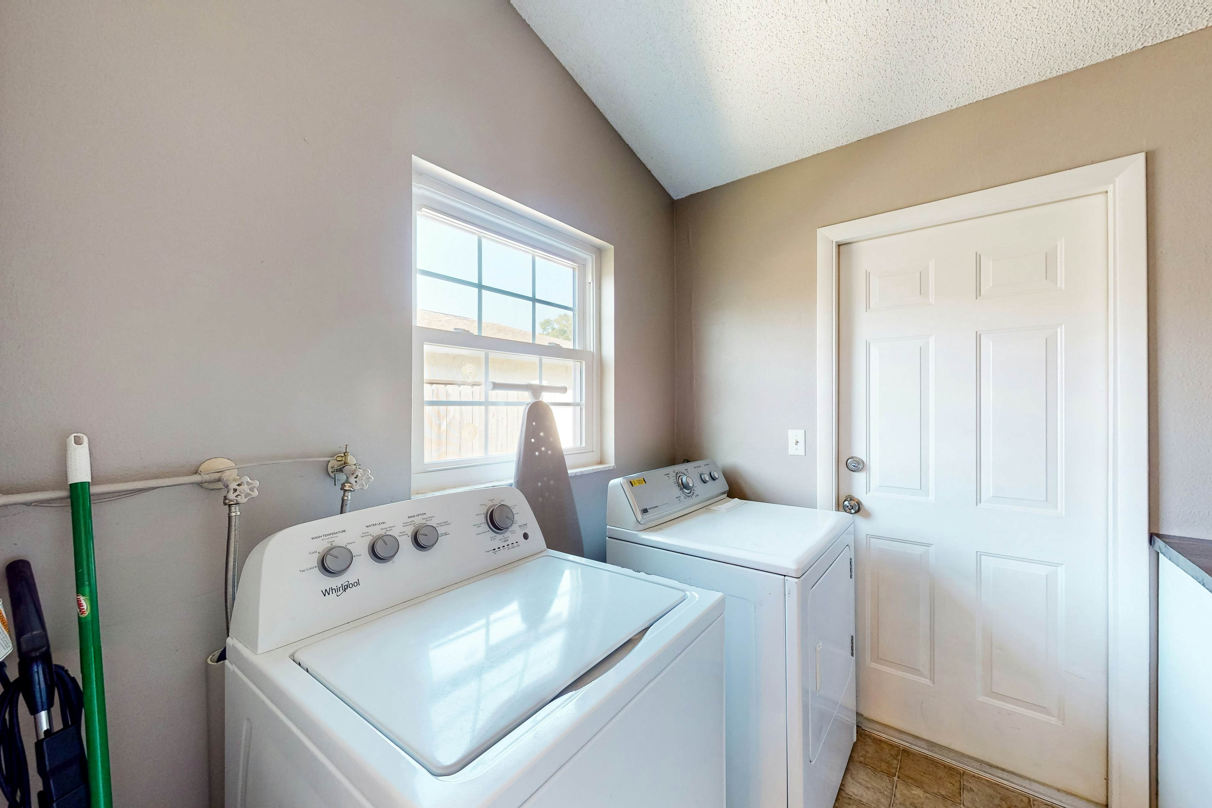 Dog-friendly house with patio, firepit, fenced yard, beach gear, & AC