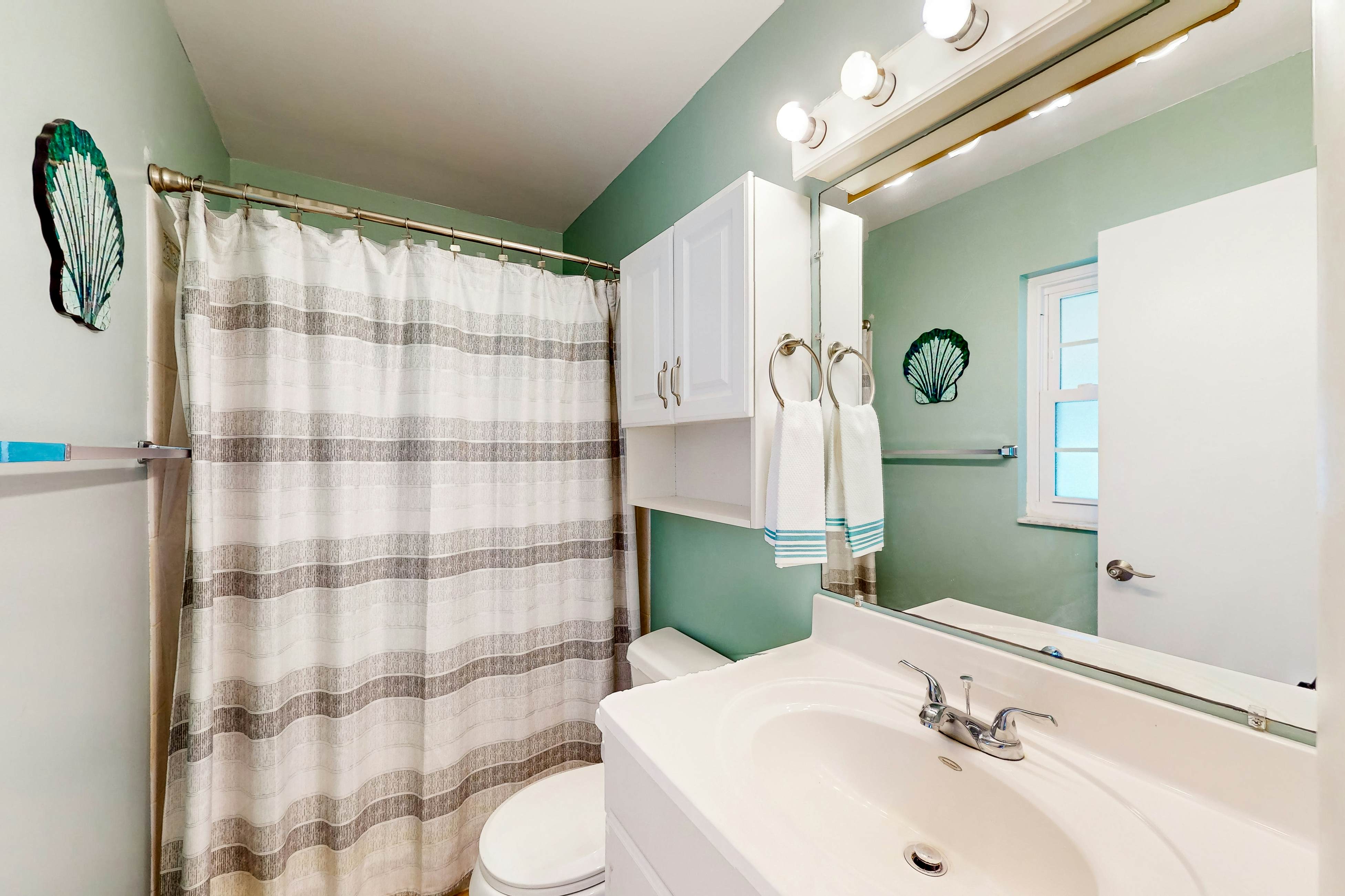 Dog-friendly house with patio, firepit, fenced yard, beach gear, & AC