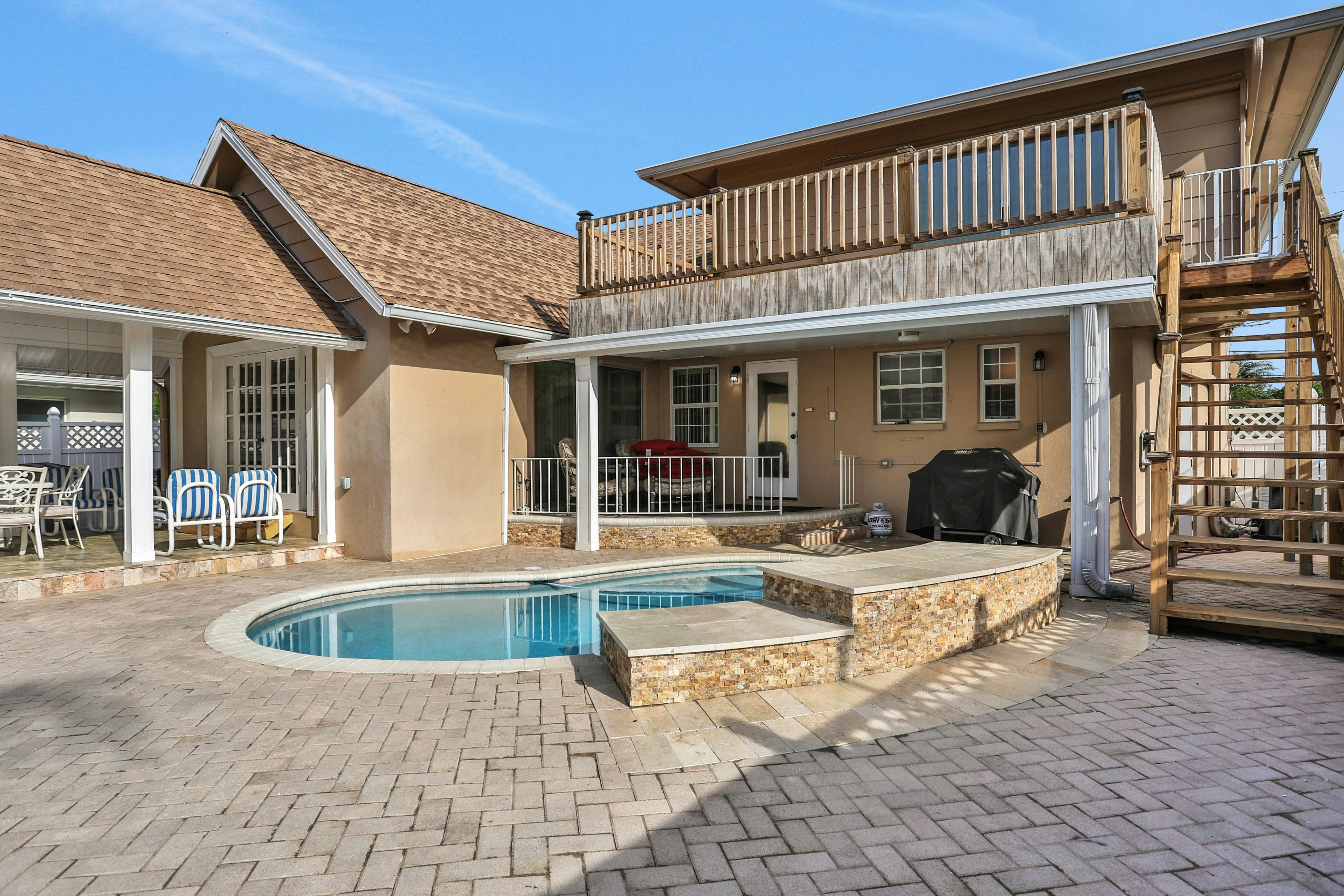 Snowbird-friendly elegant home with waterfront location, pool, grill, fireplace