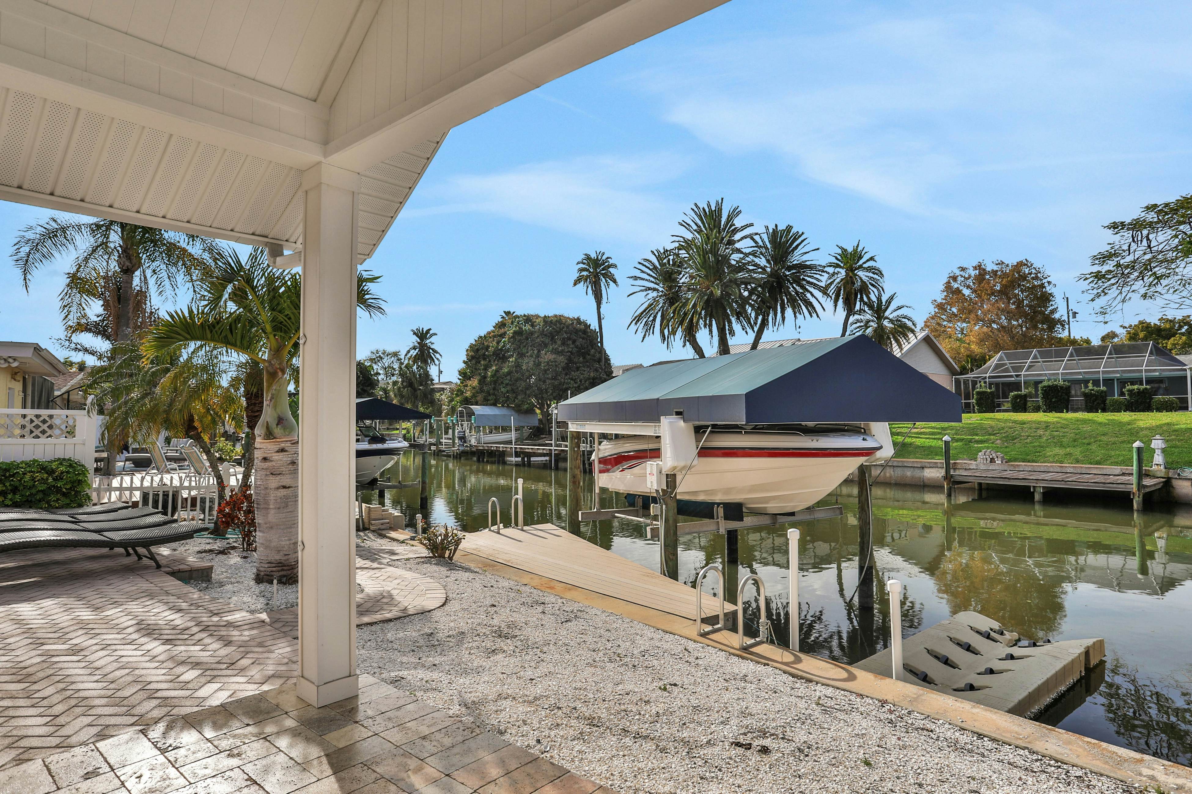 Snowbird-friendly elegant home with waterfront location, pool, grill, fireplace