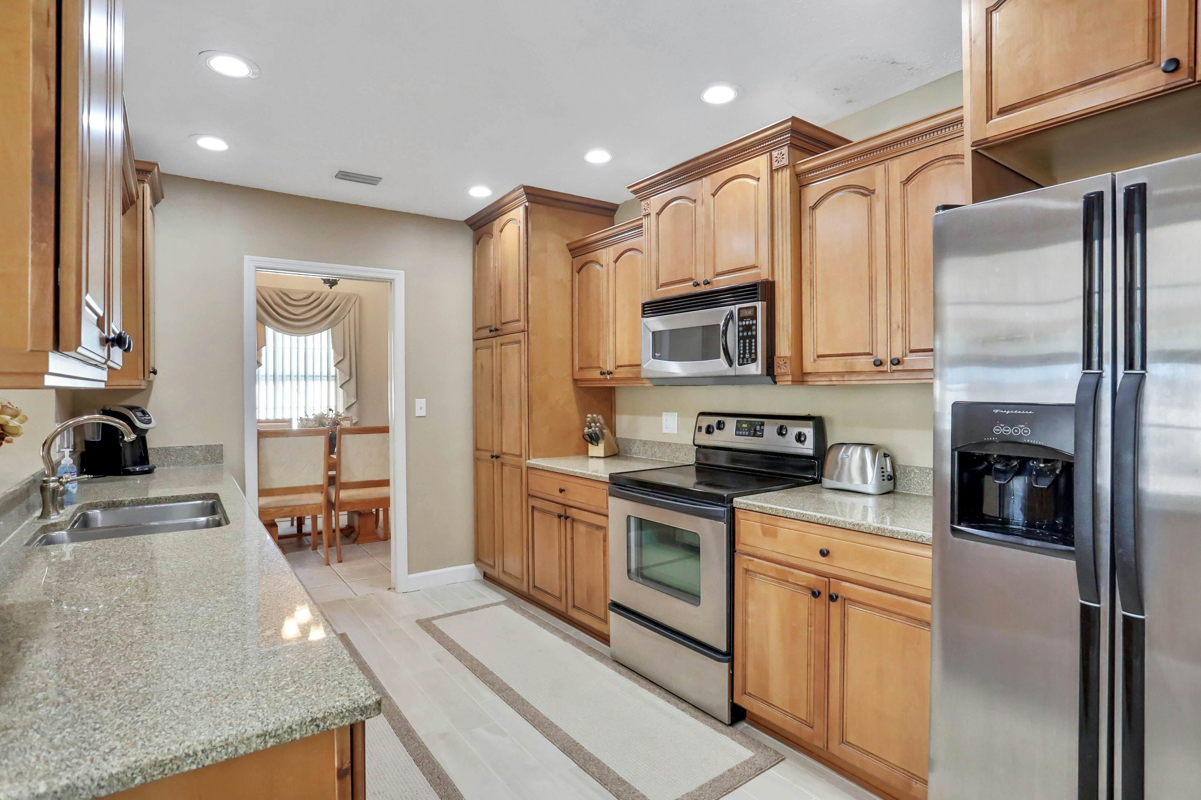 Snowbird-friendly elegant home with waterfront location, pool, grill, fireplace