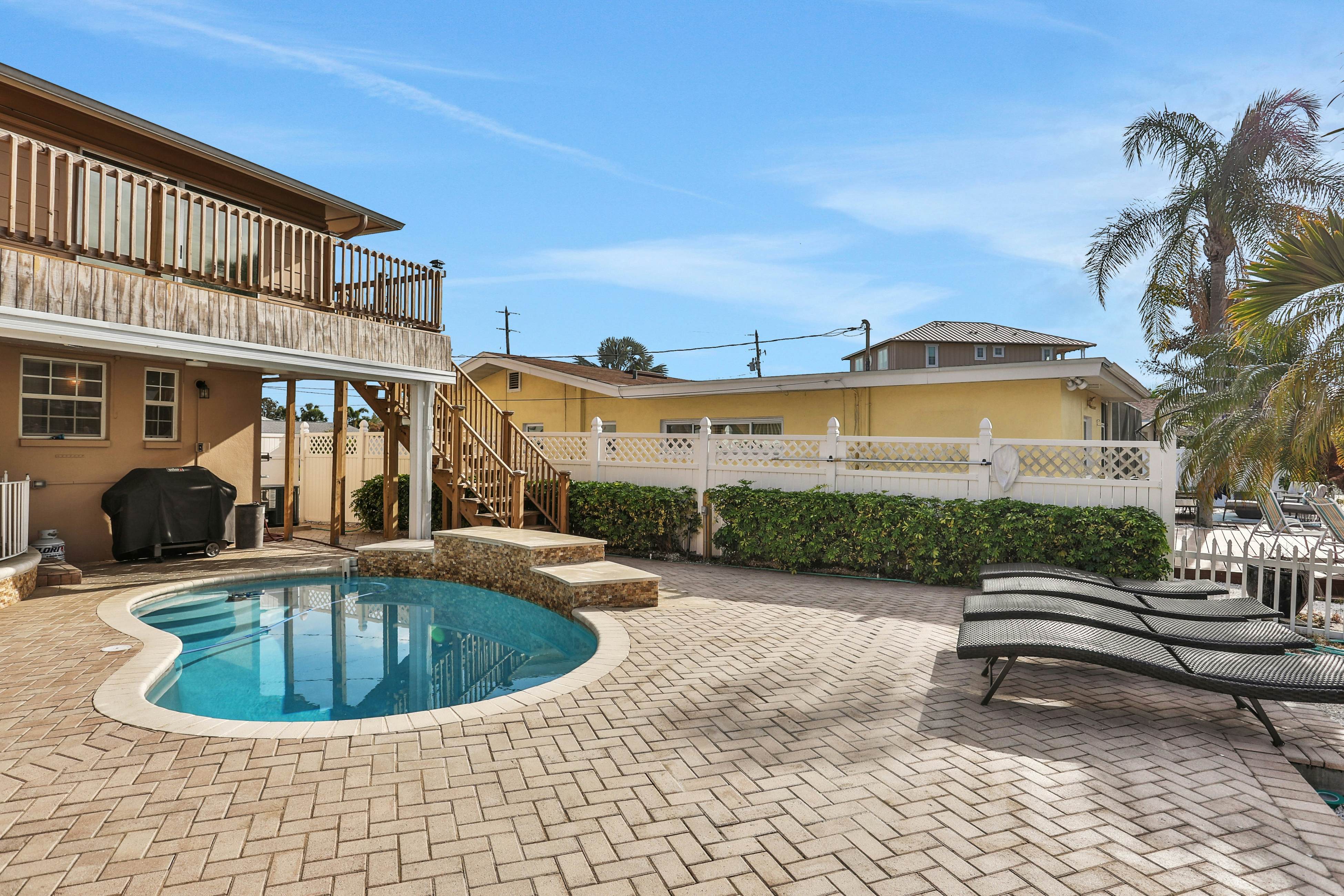 Snowbird-friendly elegant home with waterfront location, pool, grill, fireplace