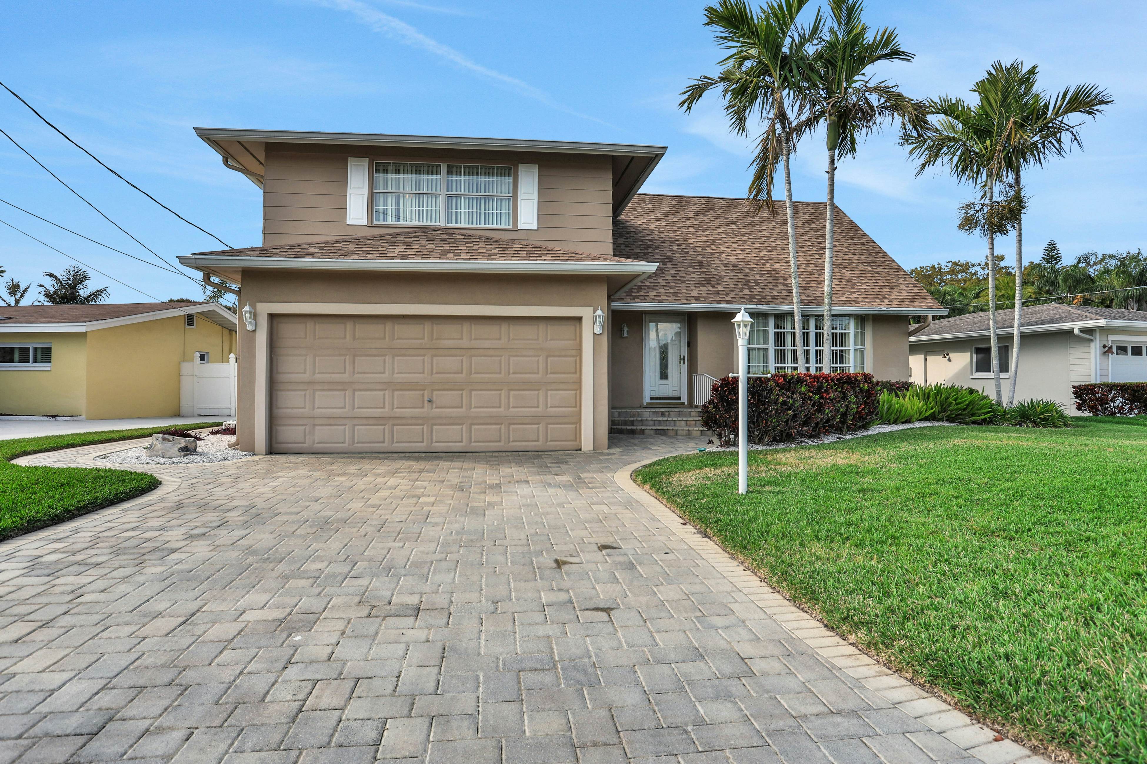 Snowbird-friendly elegant home with waterfront location, pool, grill, fireplace