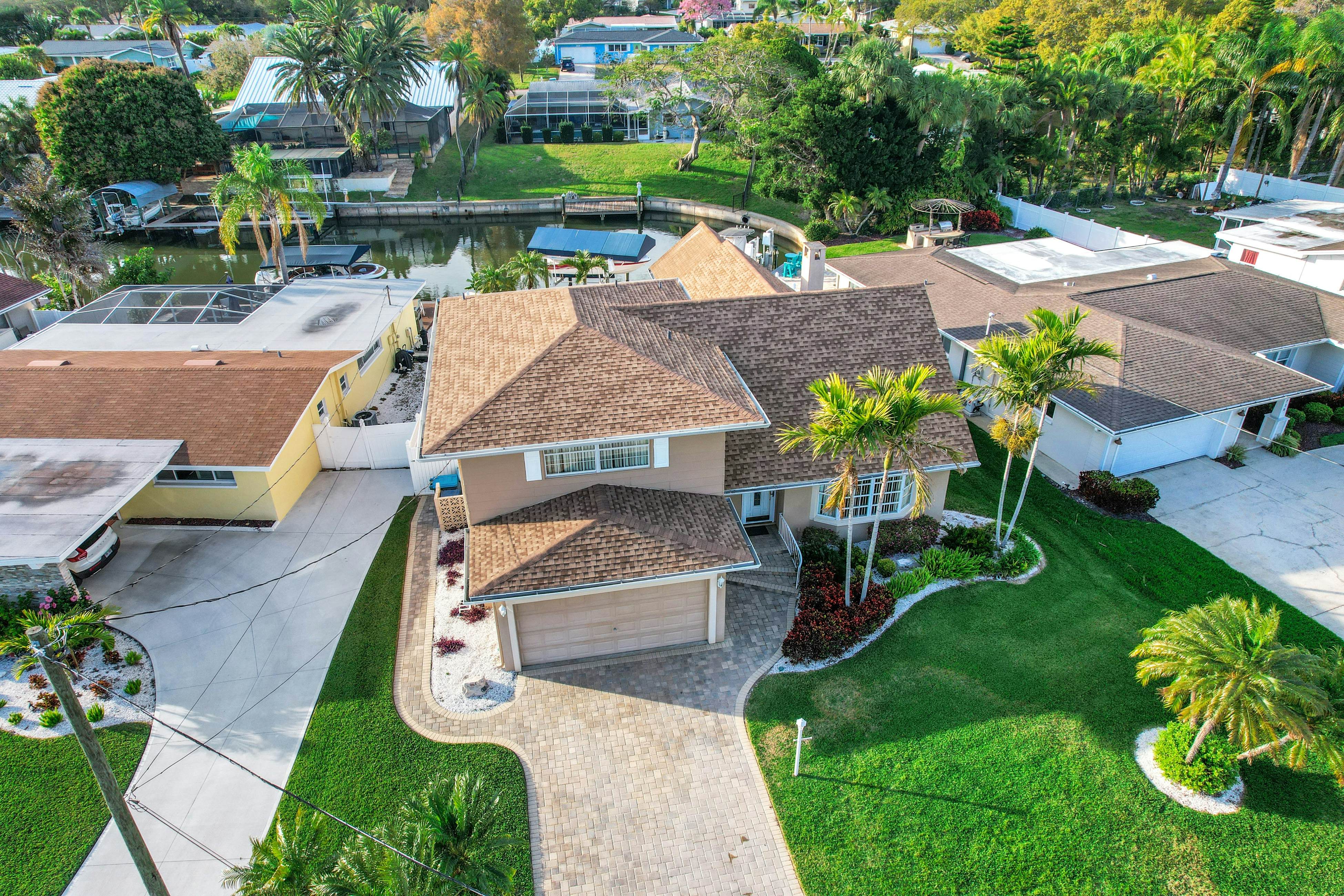 Snowbird-friendly elegant home with waterfront location, pool, grill, fireplace