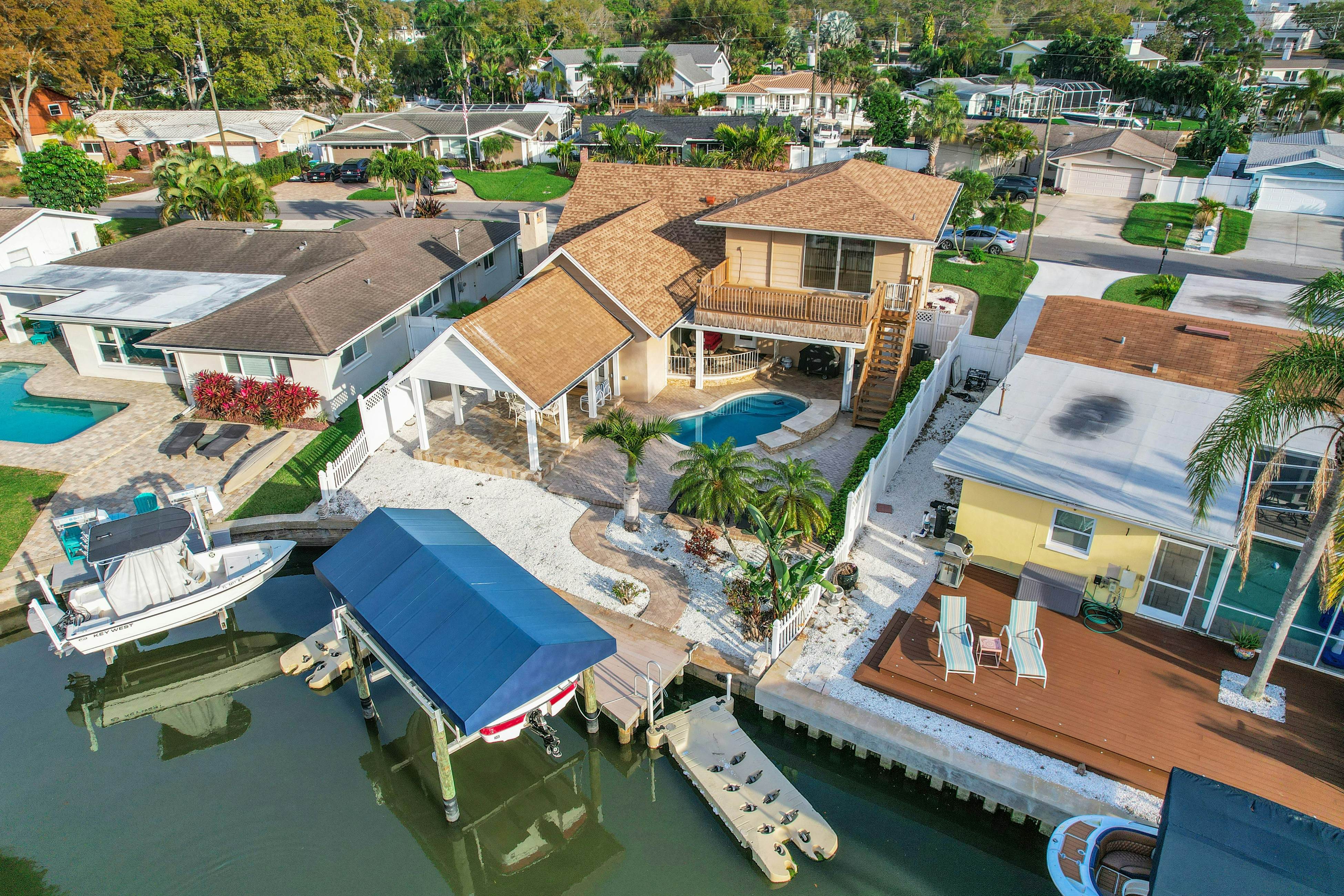 Snowbird-friendly elegant home with waterfront location, pool, grill, fireplace