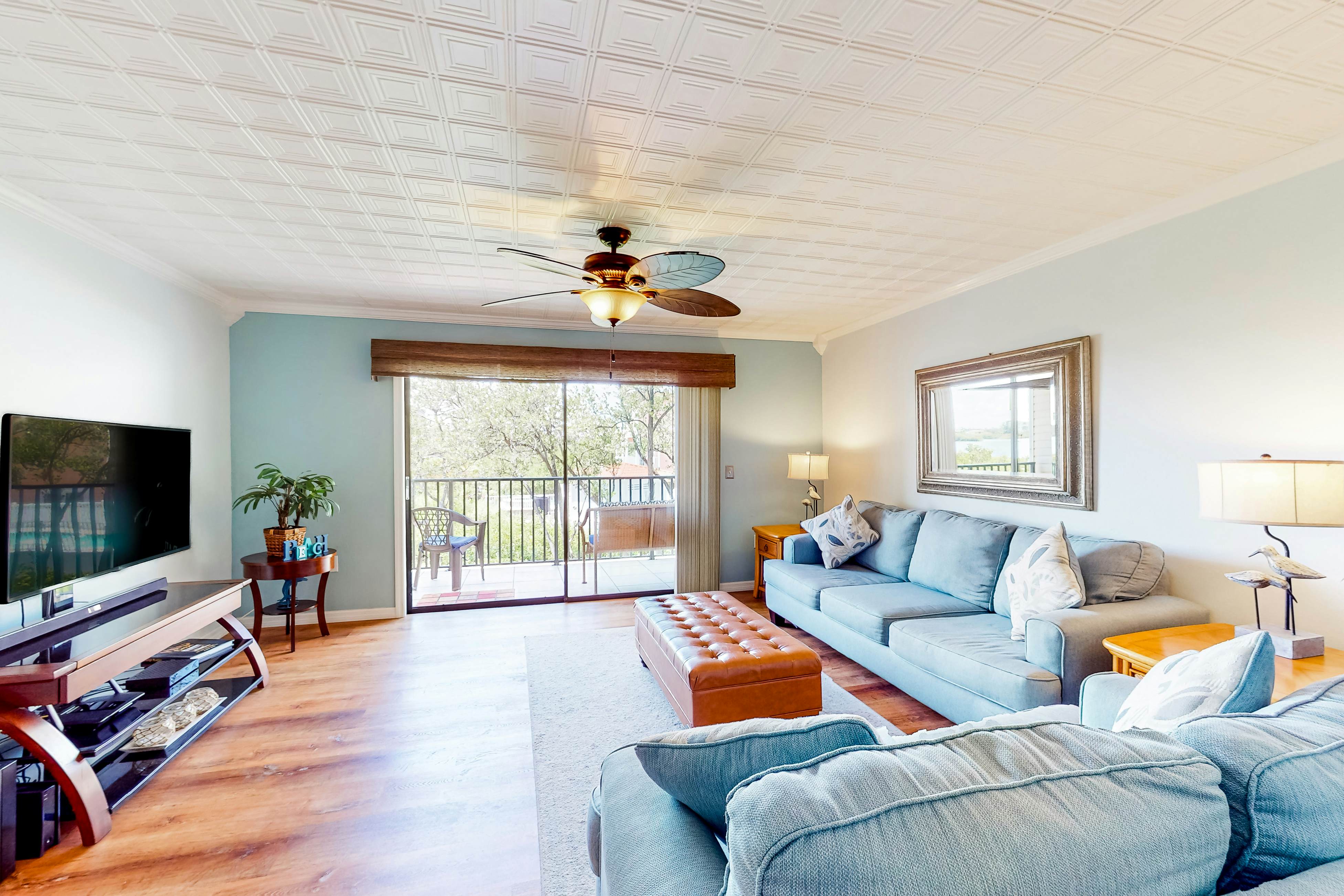 Beachfront condo with balconies, grill, AC, & pool access - steps from the sand