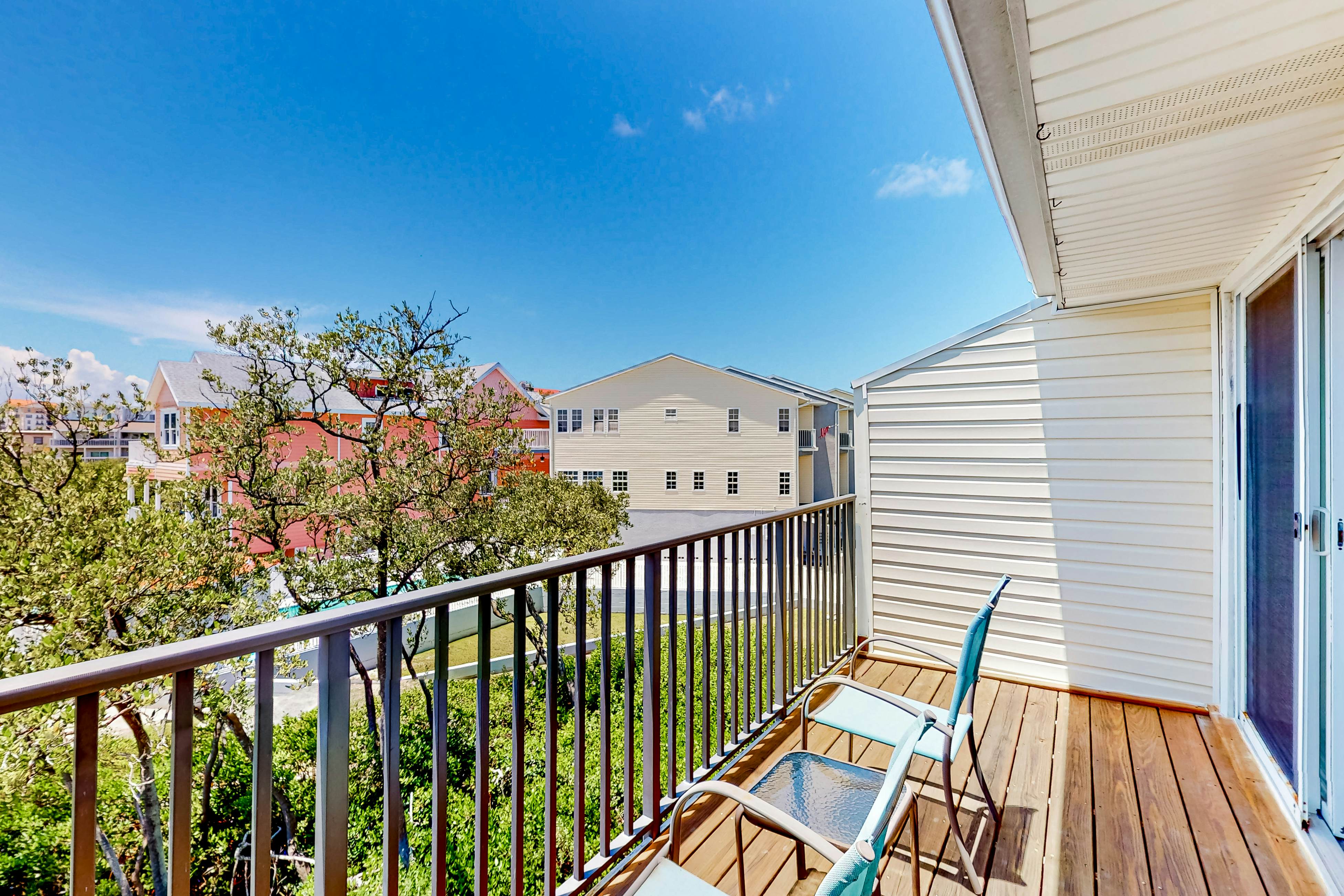 Beachfront condo with balconies, grill, AC, & pool access - steps from the sand