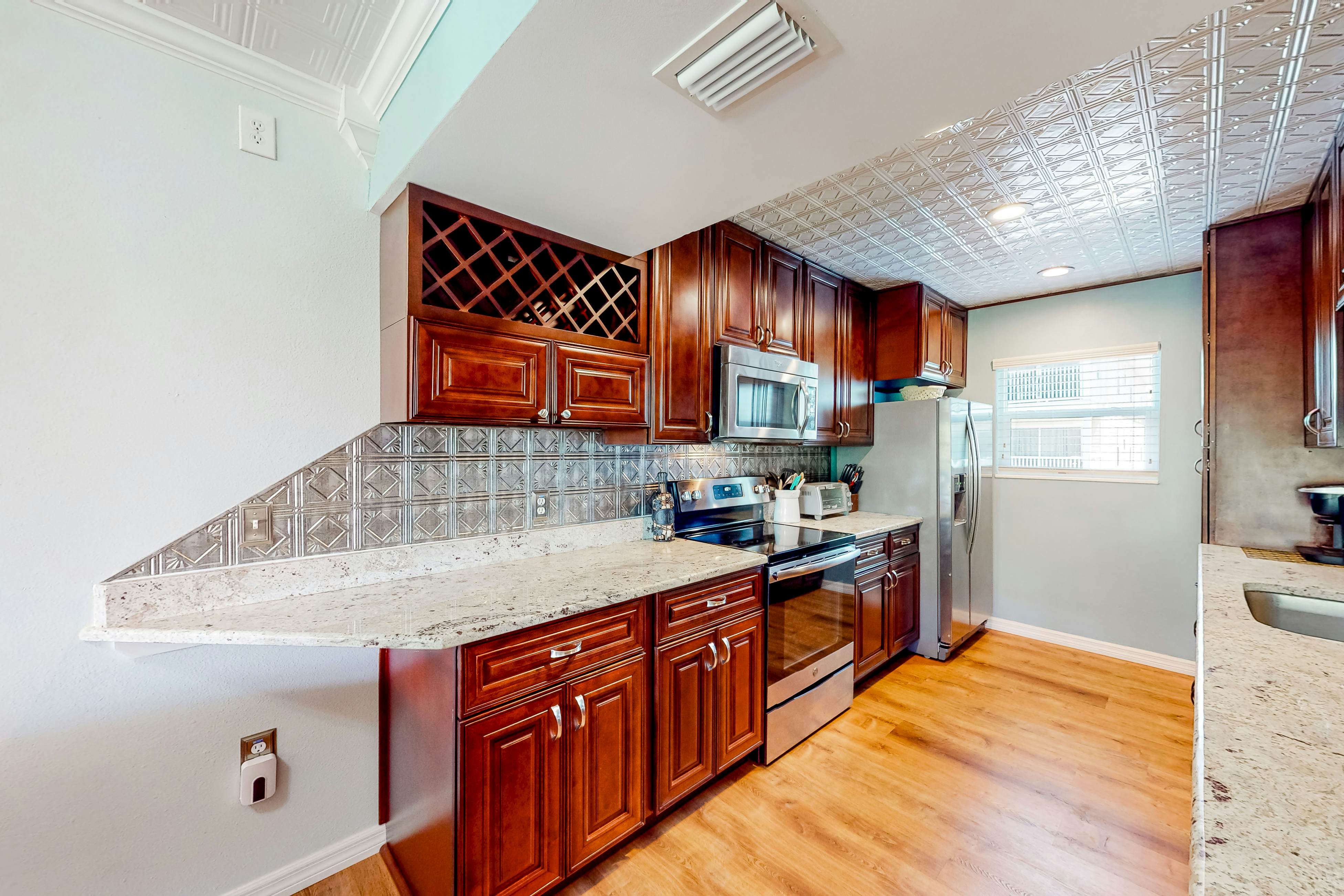 Beachfront condo with balconies, grill, AC, & pool access - steps from the sand